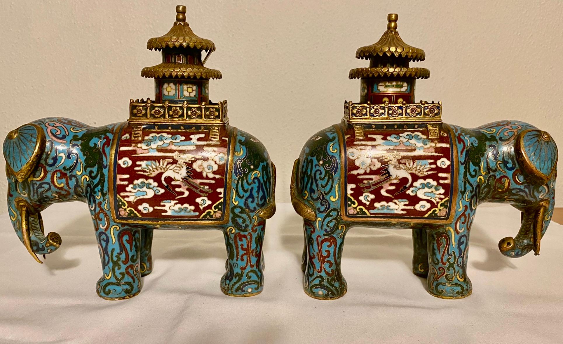 Pair of cloisonné incense burners in the form of elephants. The howdahs on the elephants backs are removable and the incense was placed inside. The howdah was used by wealthy people during processions, hunting or even warfare. The base is a deep