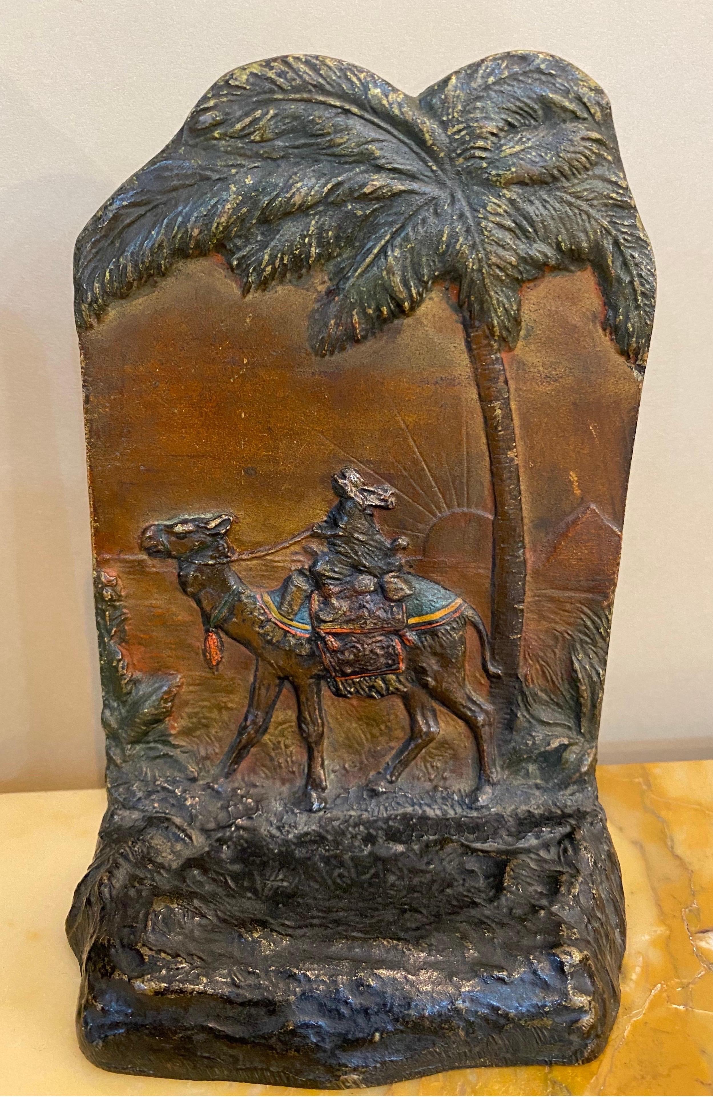 Pair of late 19th-early 20th century cold painted Austrian polychrome bookends of Arabian merchants, palm trees and pyramids in the background.