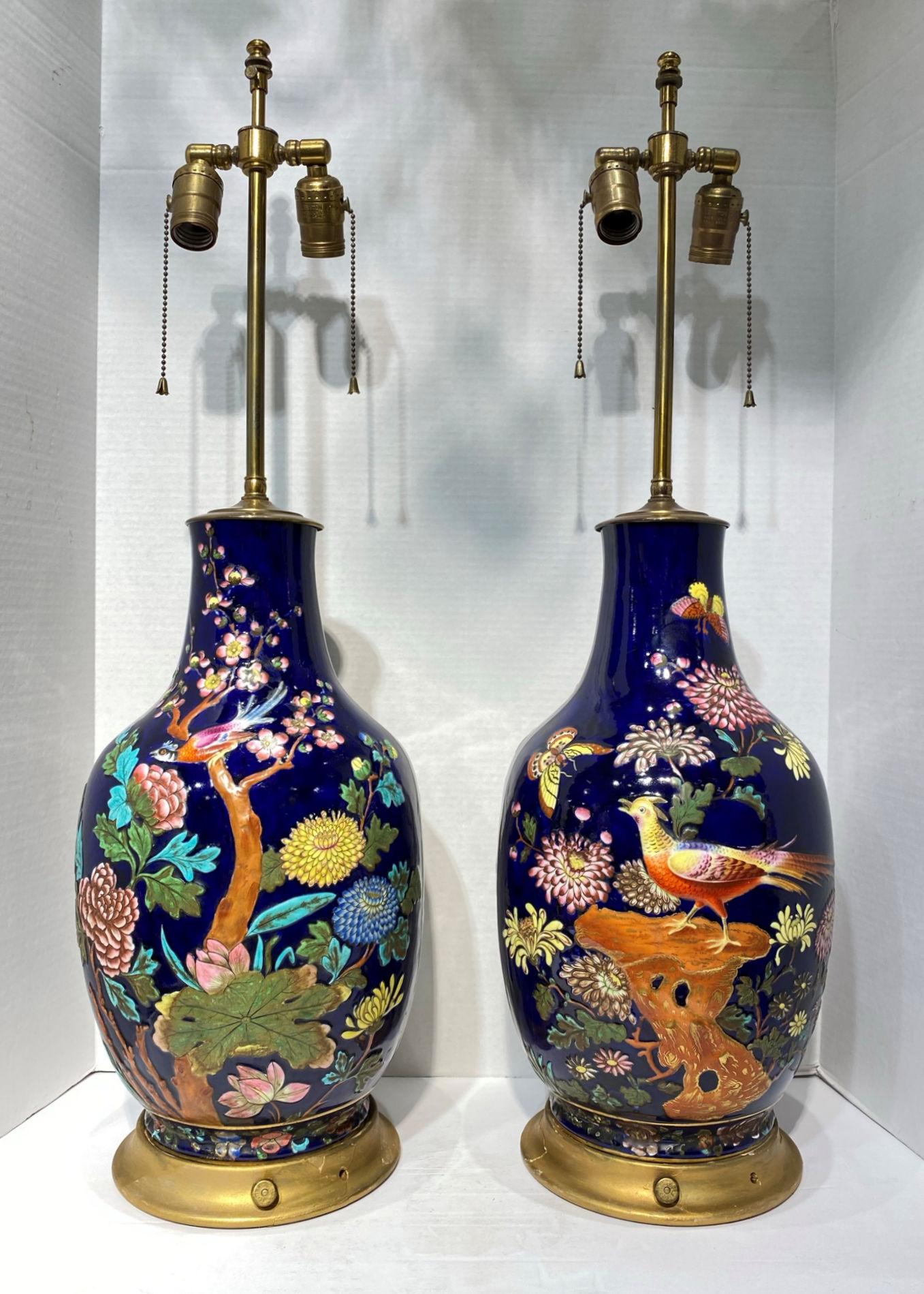Pair of late 19th century colorful enameled porcelain table Lamps with bird, flowers and butterfly motifs.
The decorations are raised and two dimensional. Extremely nice quality painting.
The porcelain vases could be French or English.