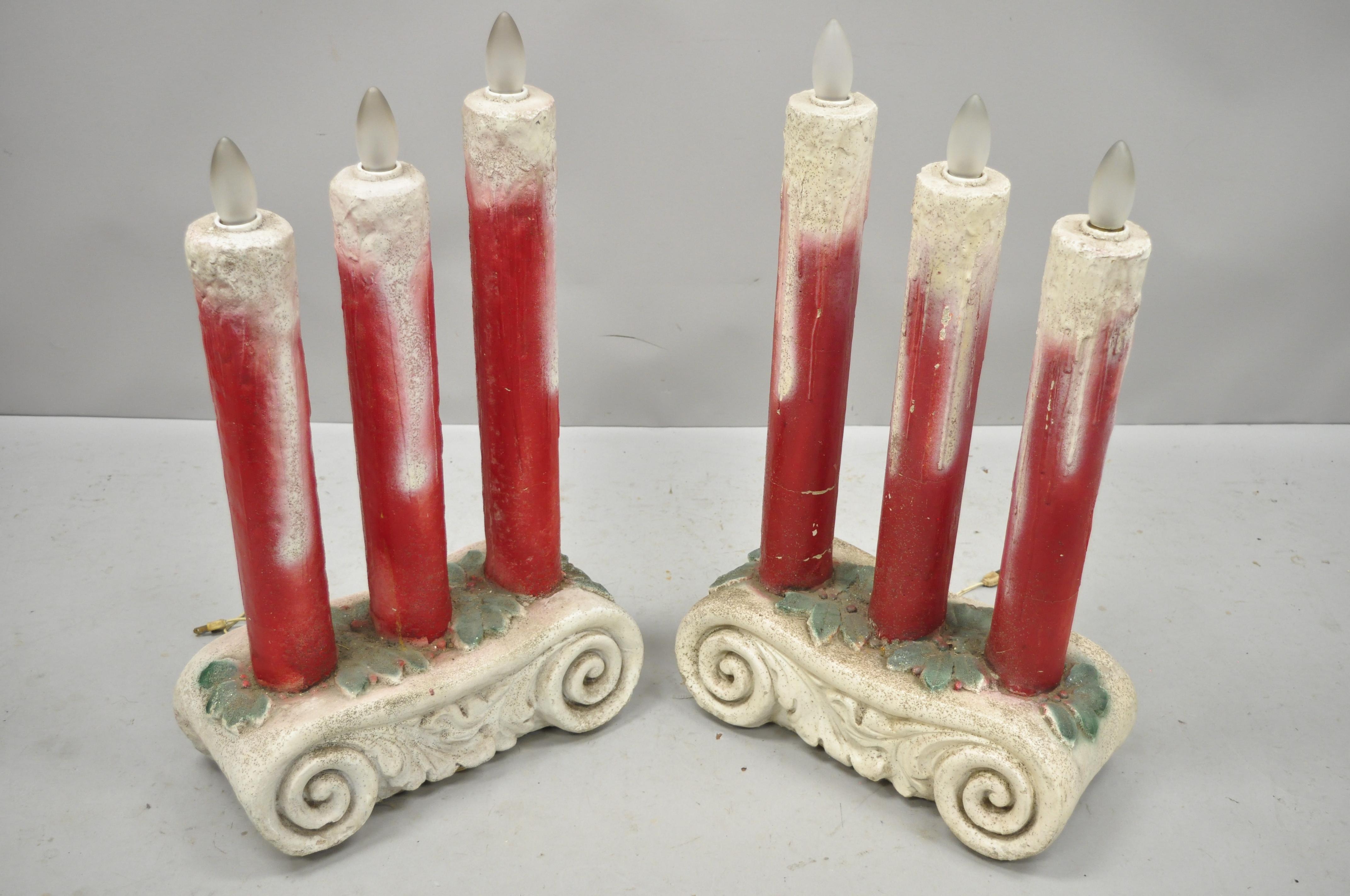 Pair of cast concrete 3 light Christmas candle candelabra architectural elements. Item features cast cement forms, 3 lights each, scrolling pedestal base, great style and form, approximately 80 lbs each, circa mid-20th century. Measurements: 25.75