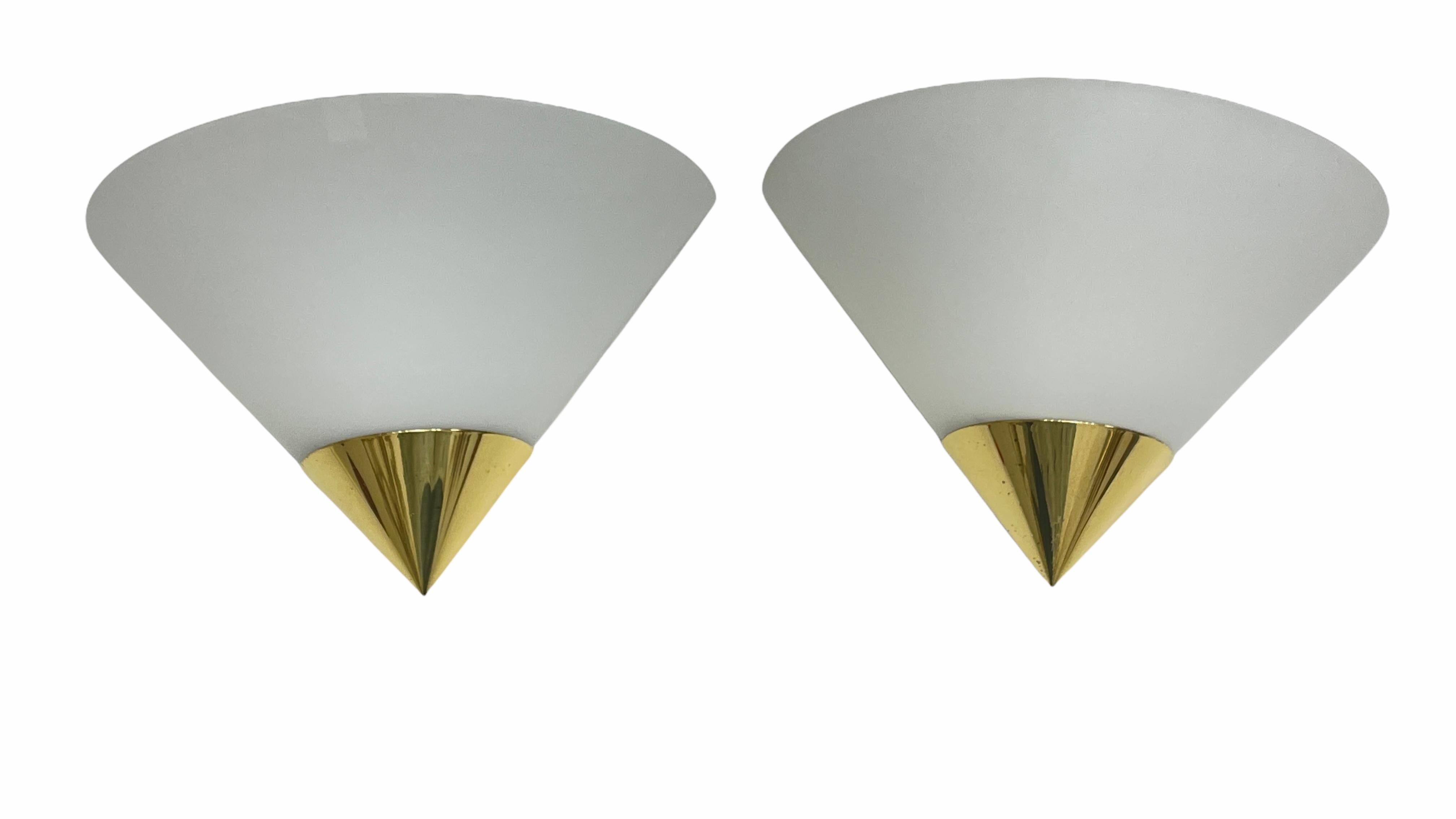A lot of two petite sconces or wall lights manufactured by Glashütte Limburg. Each has a silk toned glass on a gilt metal frame. Each fixture has one European style E14 socket. The Fixture requires one European E14 / 110 Volt Candelabra bulb, each