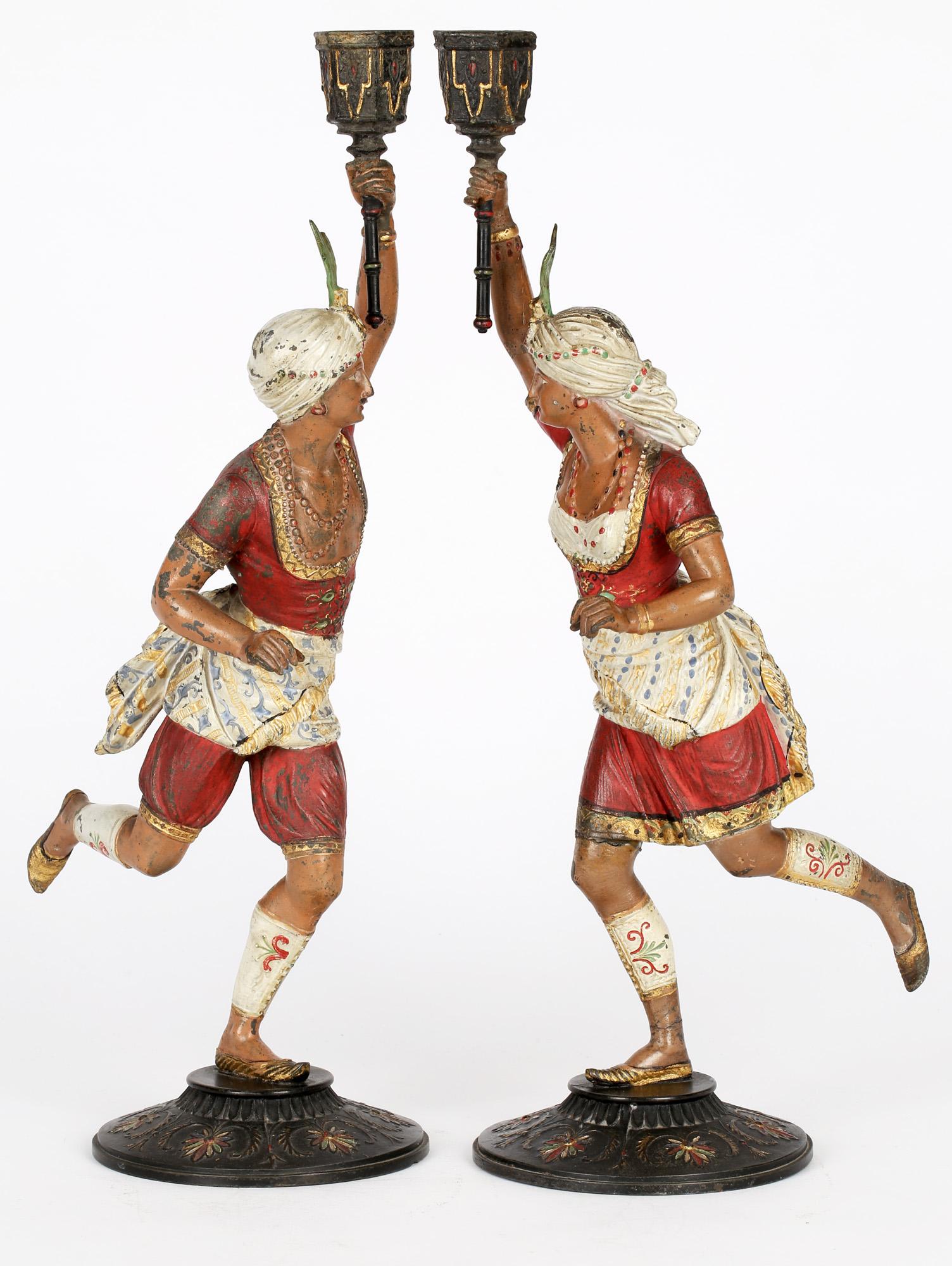 A wonderful pair of Continental, possibly French, cold painted metal Nubian figural candlesticks predating 1910. The candlesticks originate from our own family estate and have been passed down through several generations. The candlesticks portray a