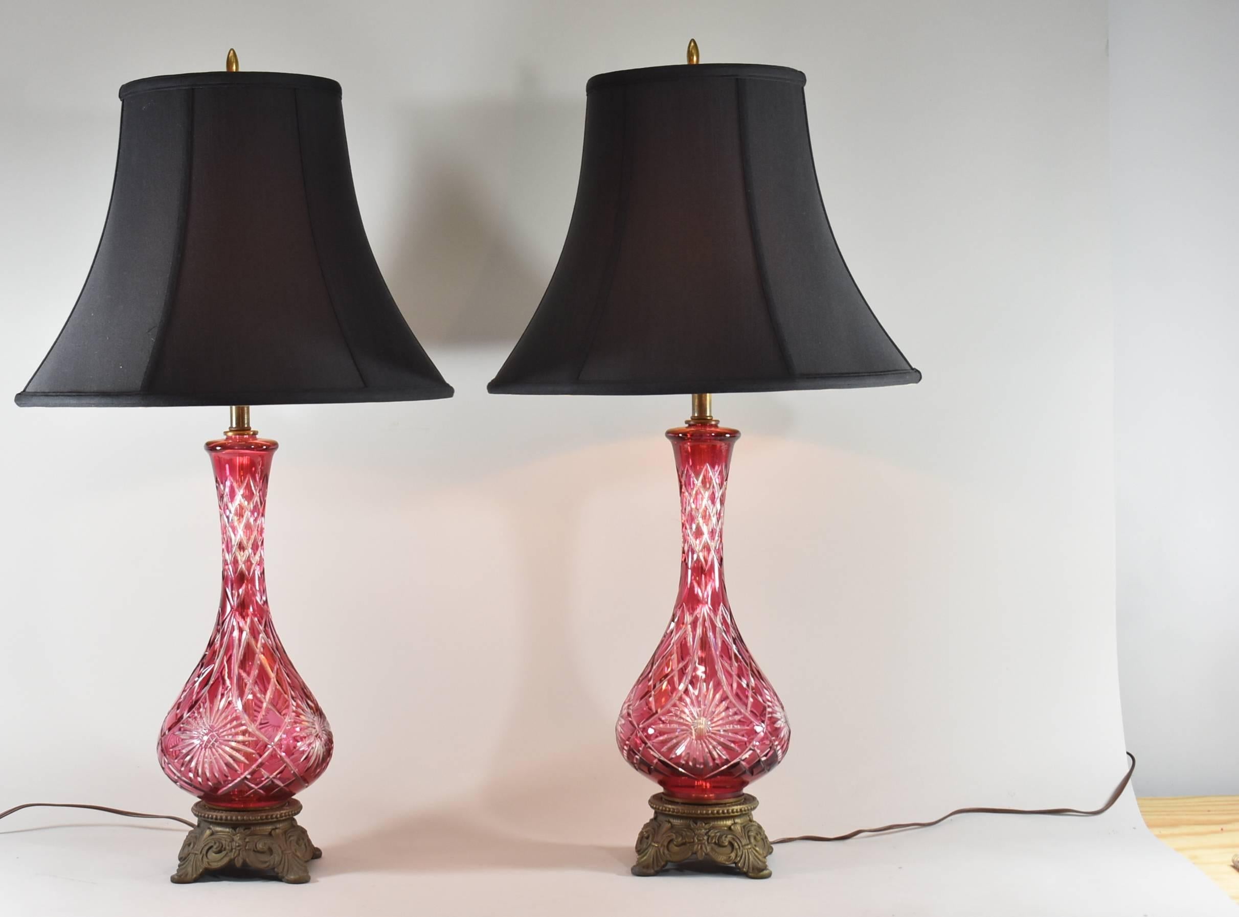 Pair of cranberry glass cut to clear table lamps with single socket. Good wiring. Very nice condition. Shades are not included.