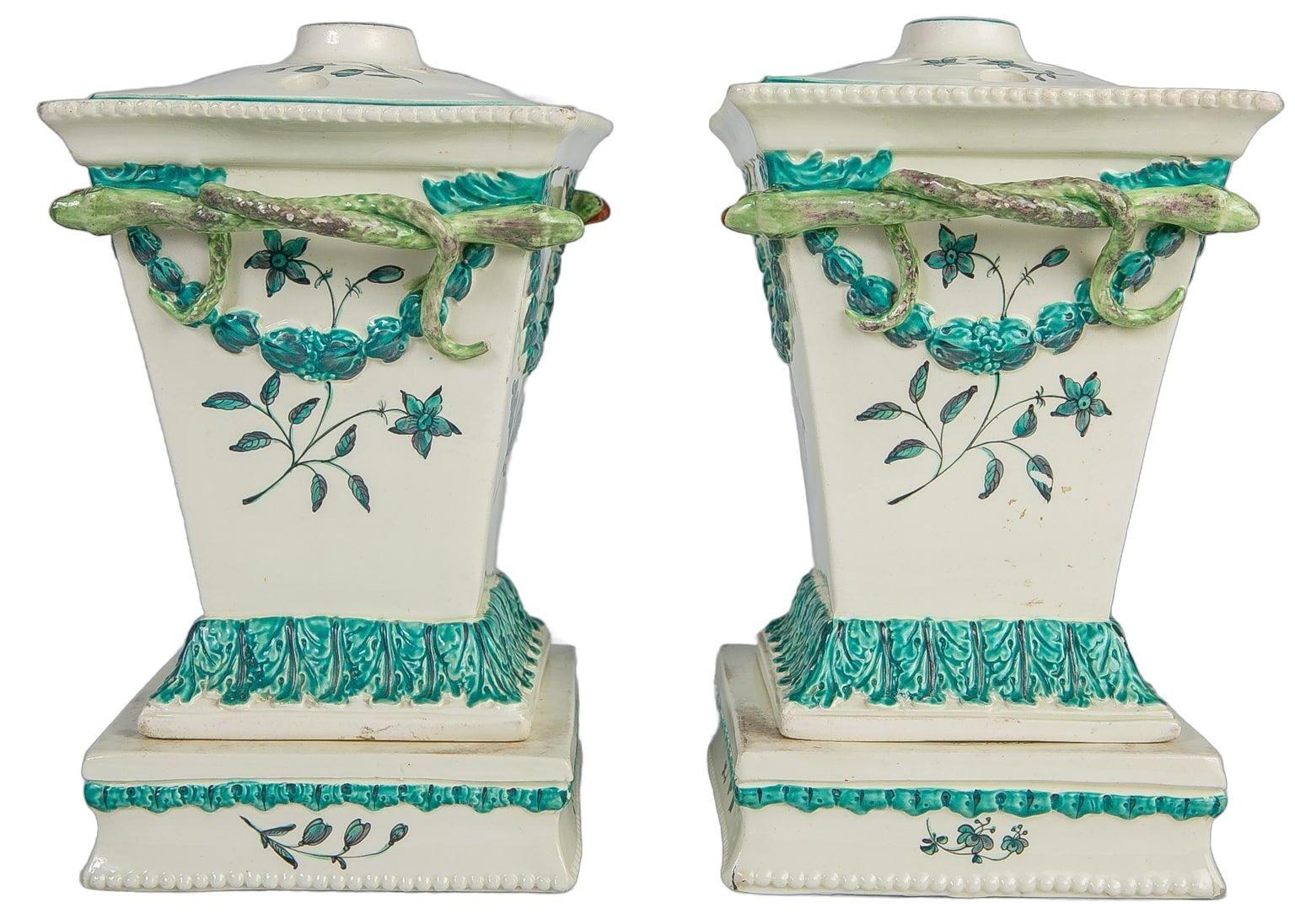 This elegant pair of English creamware flower vases, tulipieres, by Neale & Co. exemplifies the artistry and sophistication of late 18th-century English Neoclassical design.
The forms are beautifully balanced, rising from square bases with molded