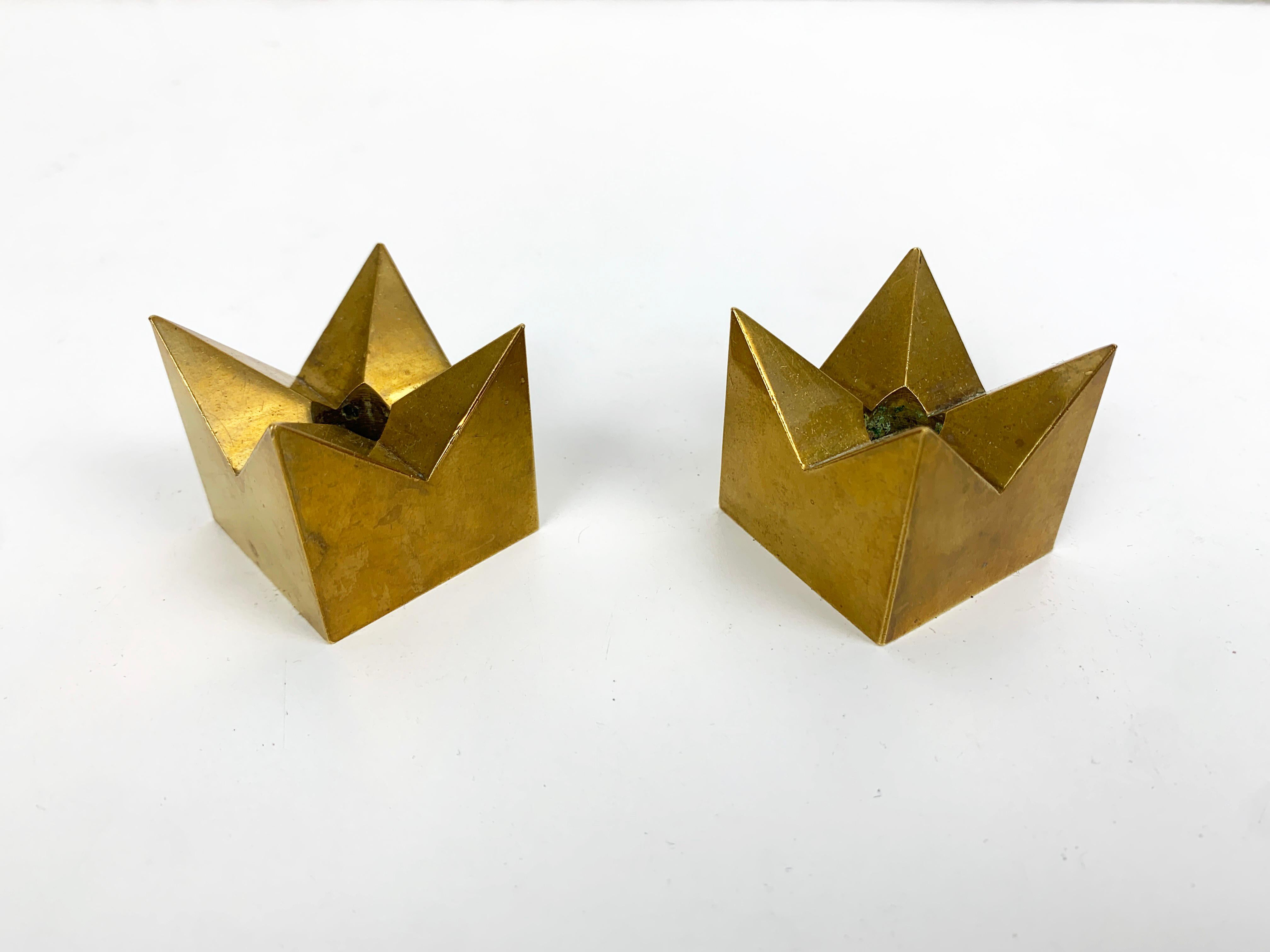 A pair of candle-sticks made of solid brass, created by Pierre Forssell. 

Designed by Pierre Forssell and manufactured in Sweden by Skultuna. The company was founded by King Carl IX of Sweden in 1607. Pierre Forsell worked between 1955 and 1986 for