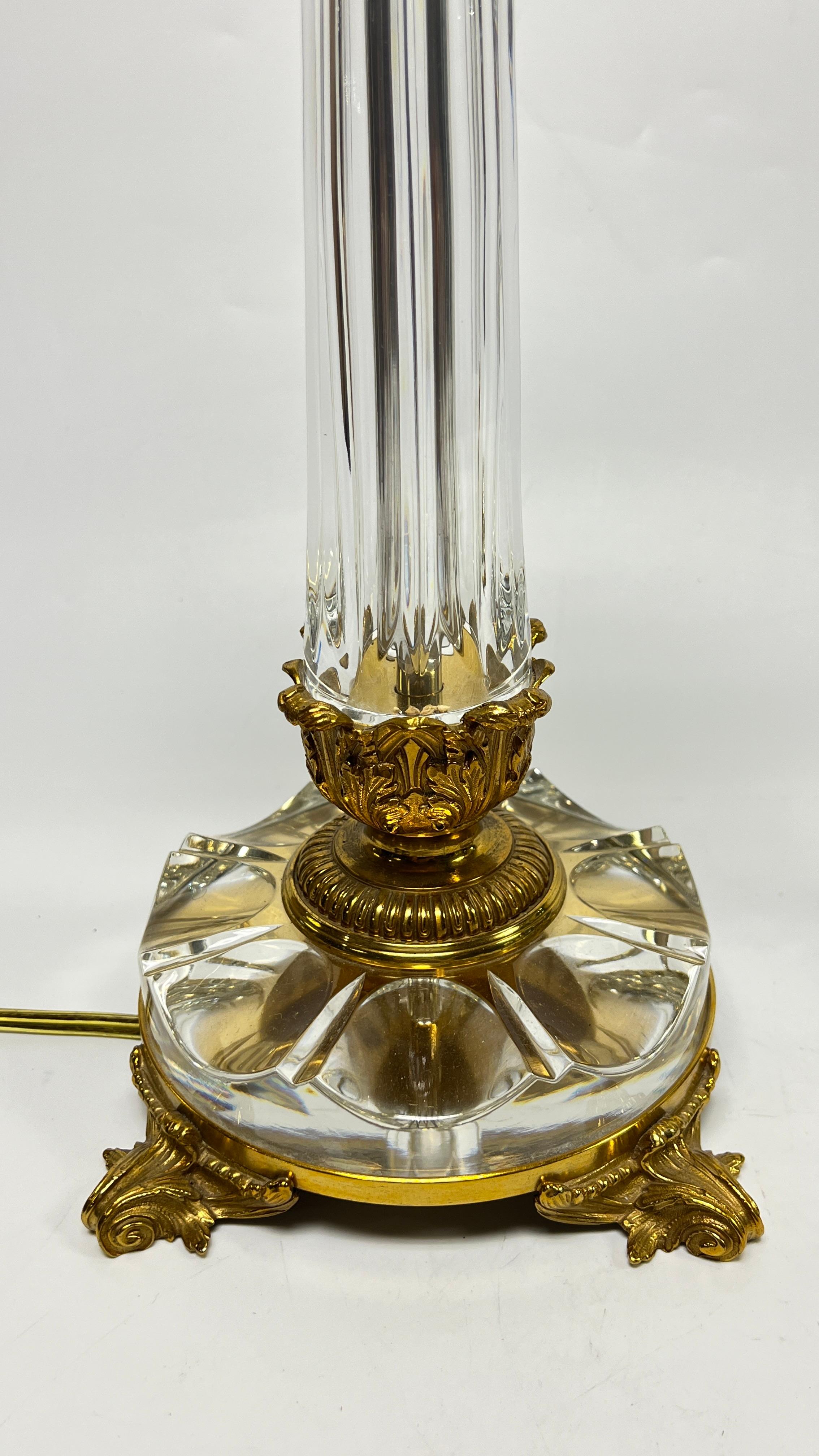 Pair of exceptional table lamps finely crafted from gilt bronze and crystal glass, of Roman column form with Corinthian capitals, each 27 by 6 1/2 by 6 1/2 inches.  