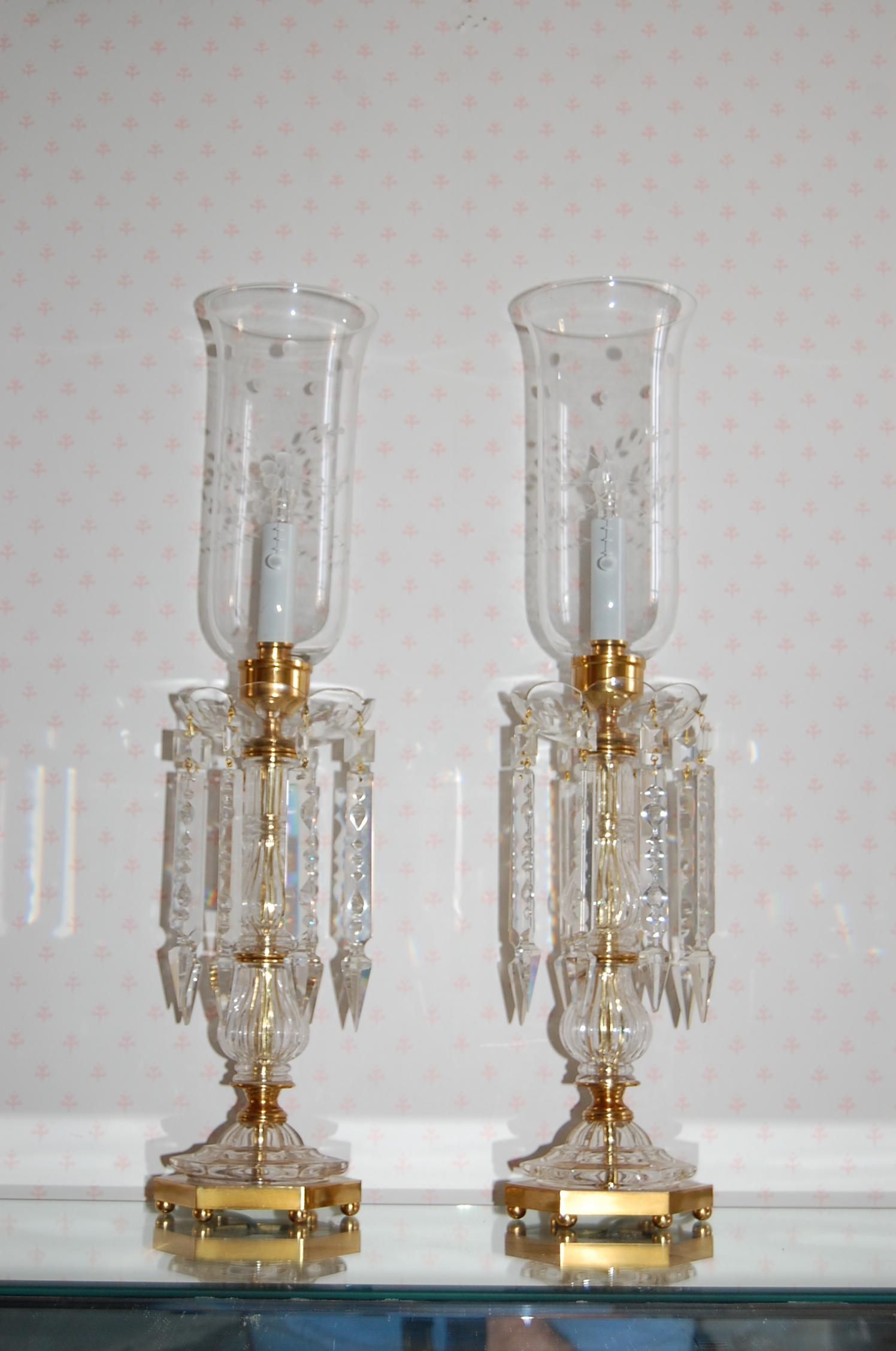 Pair of crystal lamps with glass hurricanes and long crystal drops in excellent condition. New wiring, cleaned, polished and lacquered.