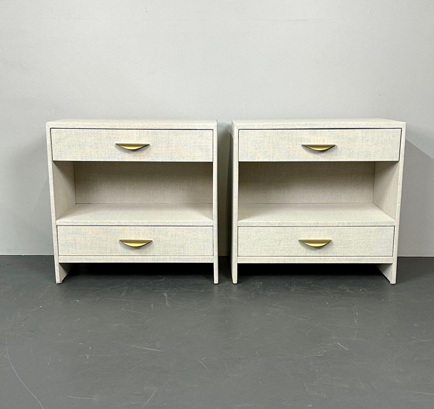 Pair custom linen wrapped open commodes, chests, nightstands, white, American.
 
Contemporary decorative cabinet hand wrapped in linen and given a multi-layered paint glaze in a neutral oyster color.
 
Measures: H 29.5
W 30
D 18.