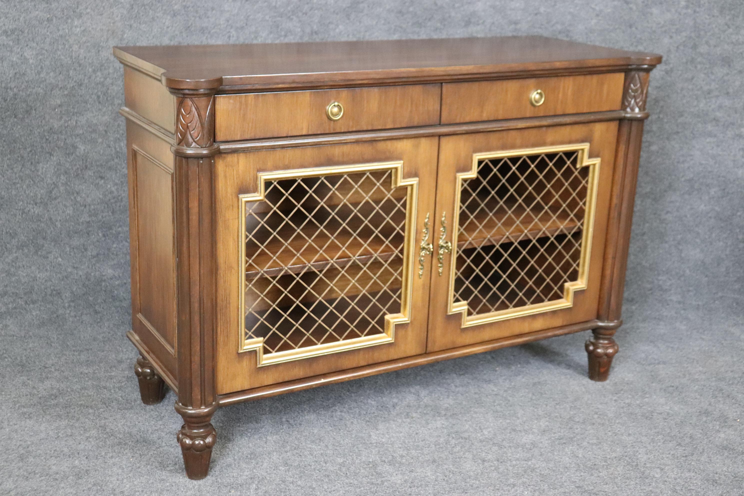 This is a gorgeous pair of American made brass grillwork and gilded mahogany side cabinets or comodes. They are in good condition and are designed in the Louis xvi or directoire style. Measures 48.5 wide x 33.25 x 18.75 deep. They date to t950-60s