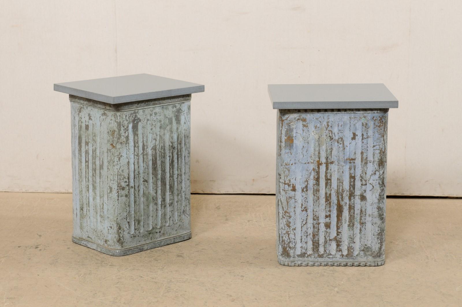 A pair of custom side tables fashioned from mid-20th century Spanish metal can bases. Each of these little tables have been created, featuring vintage metal cans from Spain (nicely ribbed/textured) as bases, with custom cut gray stone