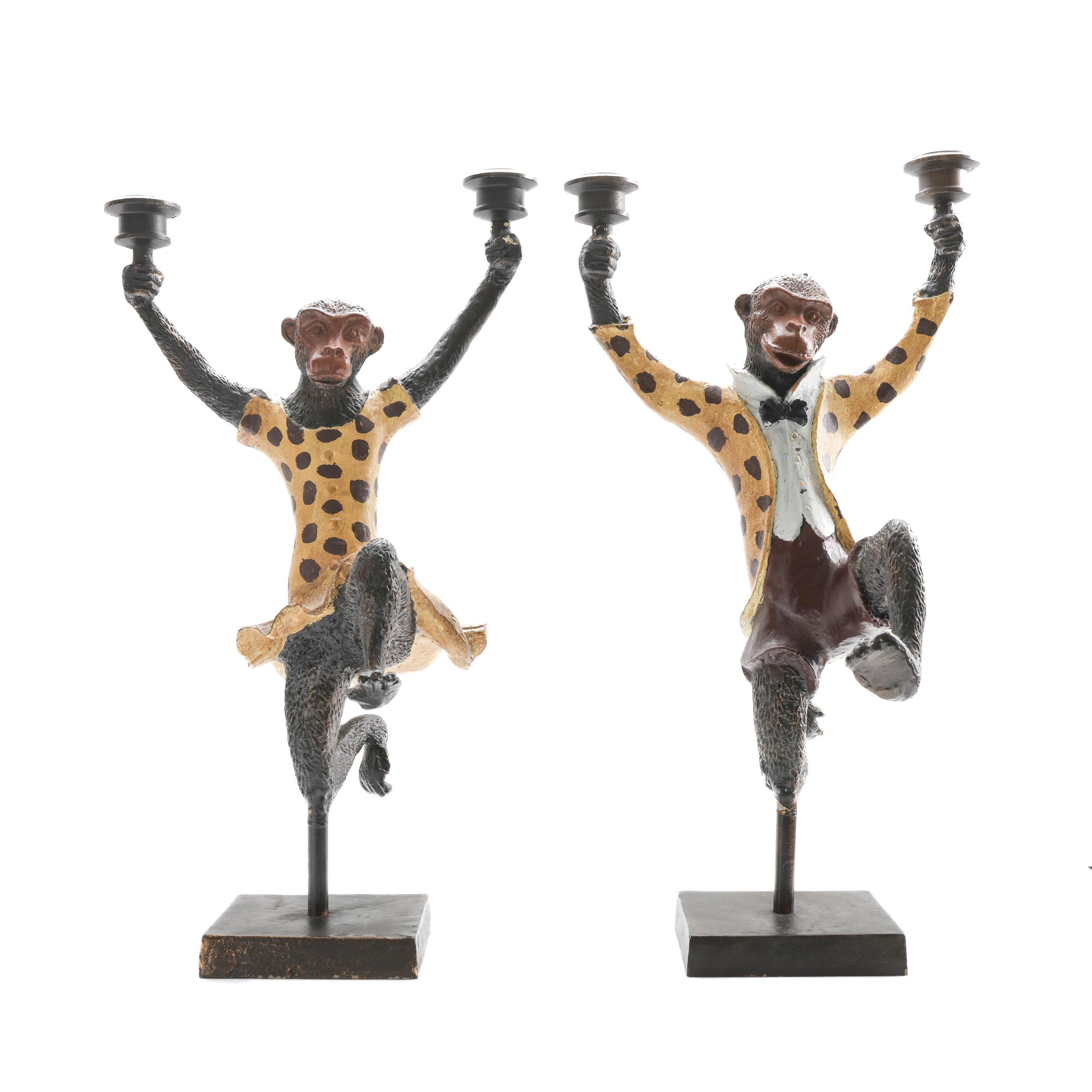Originally sold by Scully & Scully, this is a fascinating and eccentric pair of substantial iron dancing monkey sculpture candelabras. The pair is composed of a lady monkey and a gentleman monkey; she wears a yellow and black polka dot dress; he a