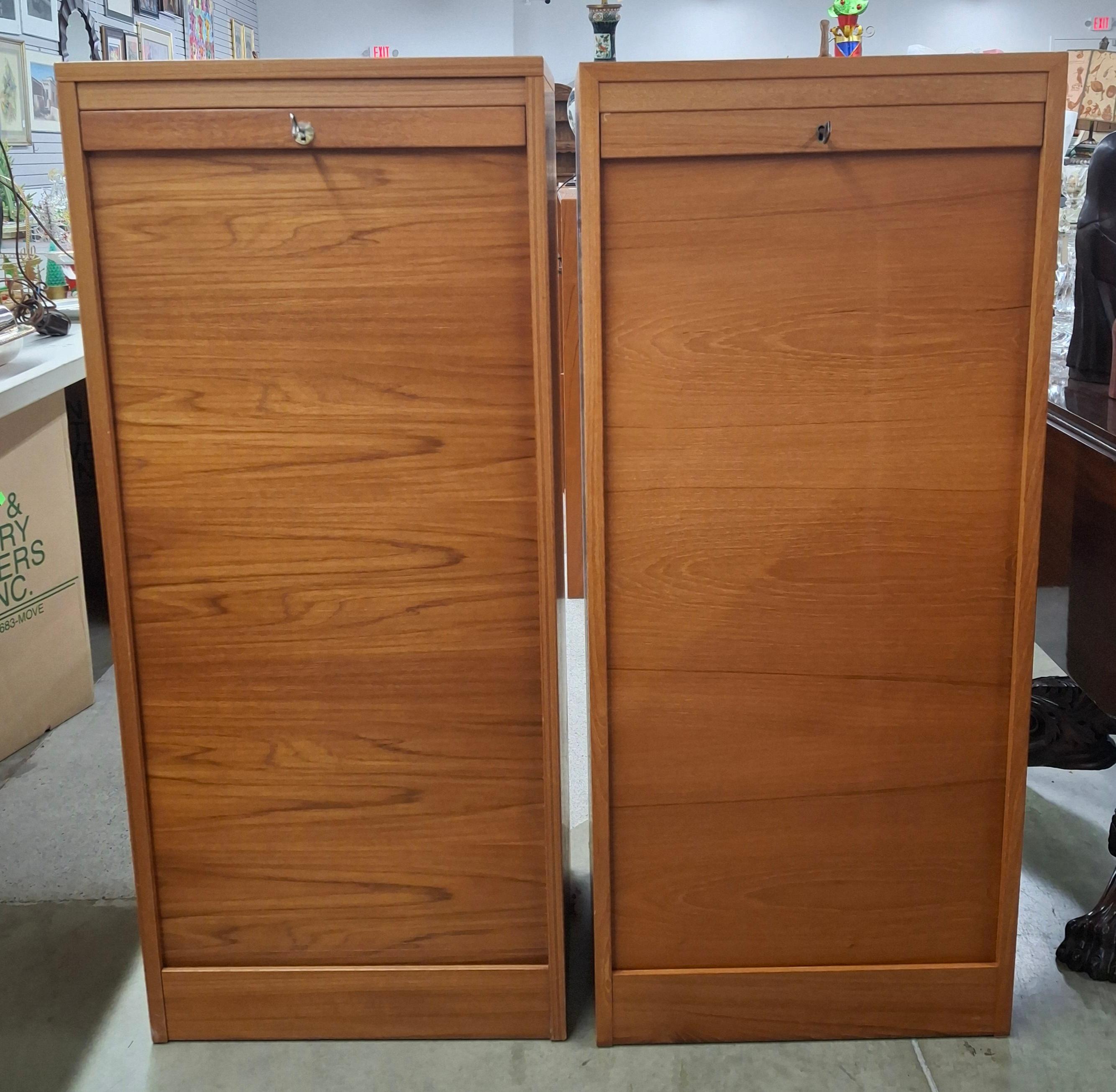 A Pair of  Danish Mid-Century Scandinavian Modern Fall Front Tambour Filing Cabinets featuring Two Top Open Drawers and 3 lower Map Style drawers. Tambour Fall front door flawlessly operating. 
Dimensions:  19.5