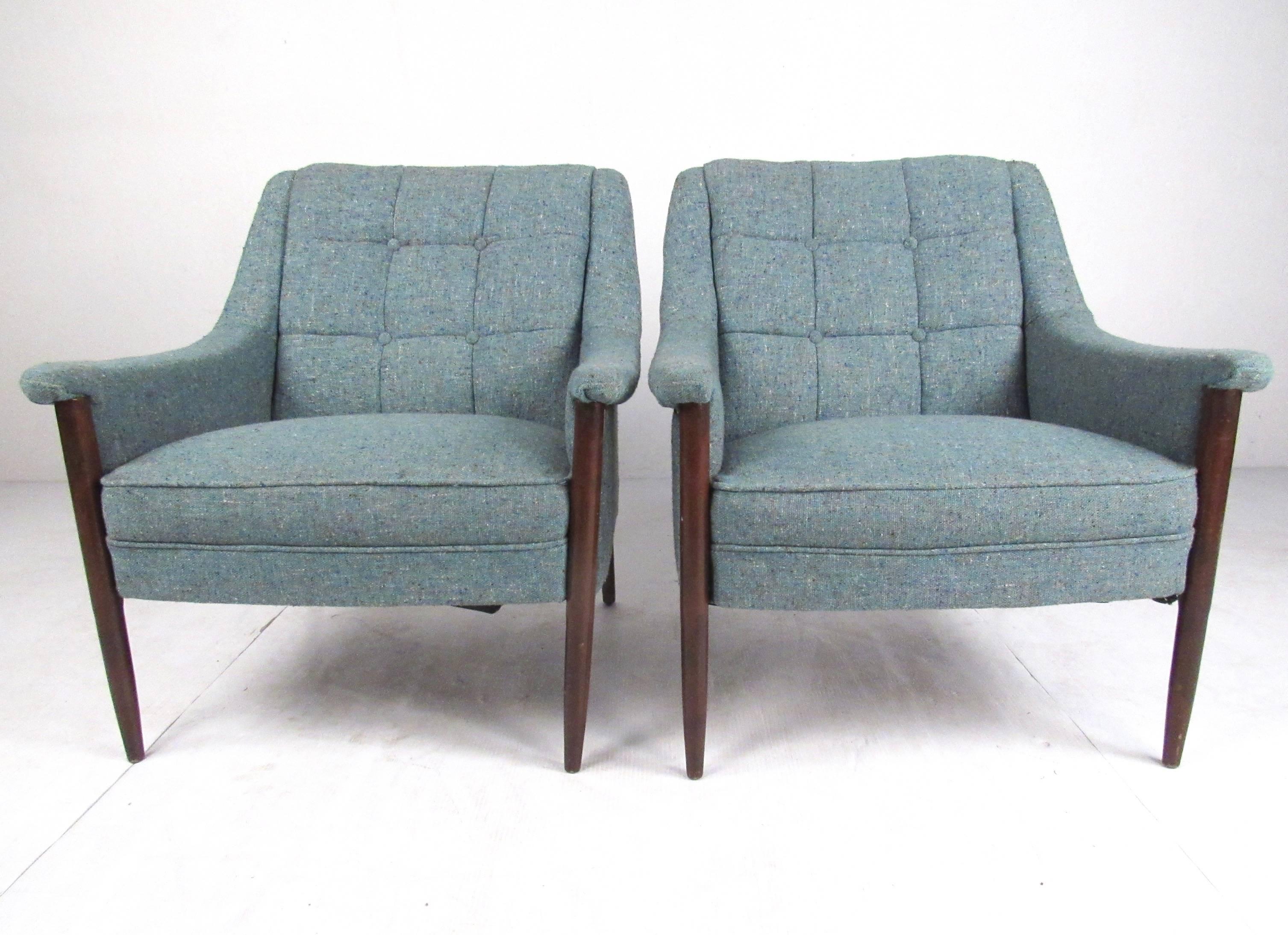 This pair of vintage modern lounge chairs feature walnut frames, shapely Danish Modern seat design, and tufted vintage fabric. Stylish Mid-Century Modern club chairs make a comfortable retro addition to home or business seating arrangement. Please
