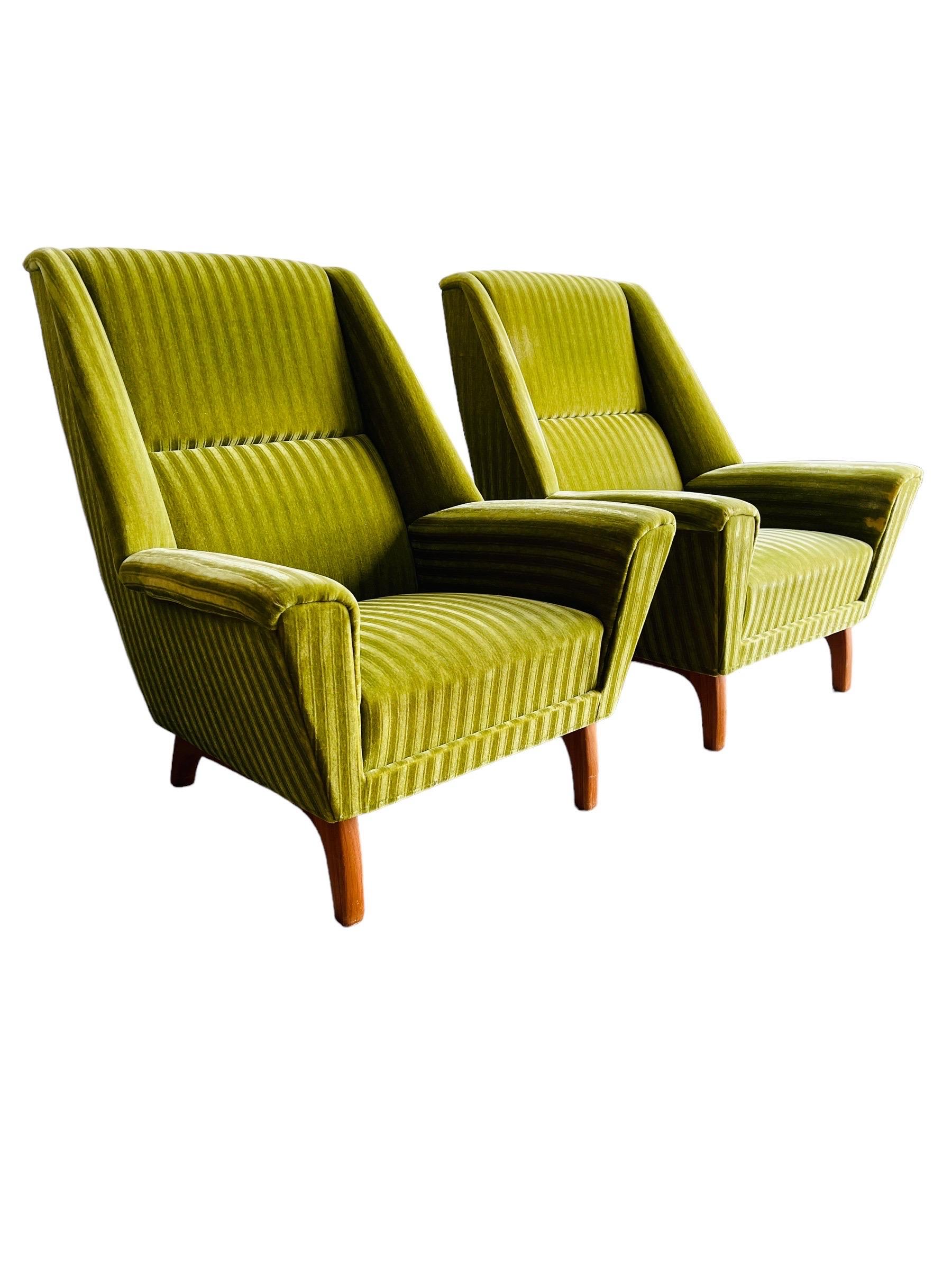 Discover the timeless elegance of these Danish modern lounge chairs, gracefully standing on warm teak legs. Their classic charm is accentuated by the vibrant green striated upholstery, which brings a pop of color and a touch of vintage flair to any