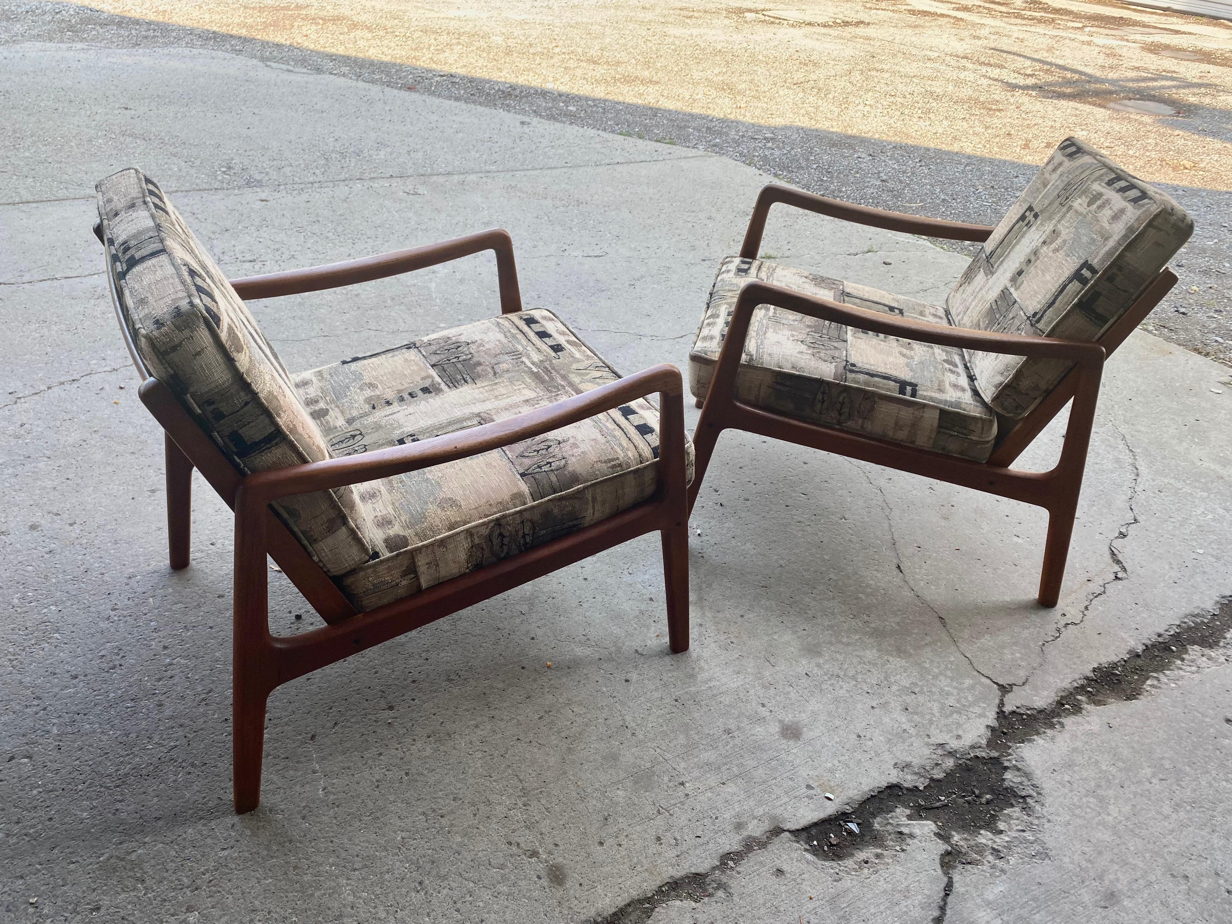 Stunning pair teak lounge chairs designed by Ole Wanscher manufactured by France & Sons,, Retains original finish ,,patina,, Newer seat and back cushions,Also retains early France & Sons metal label..Superior quality and construction,, Extremely