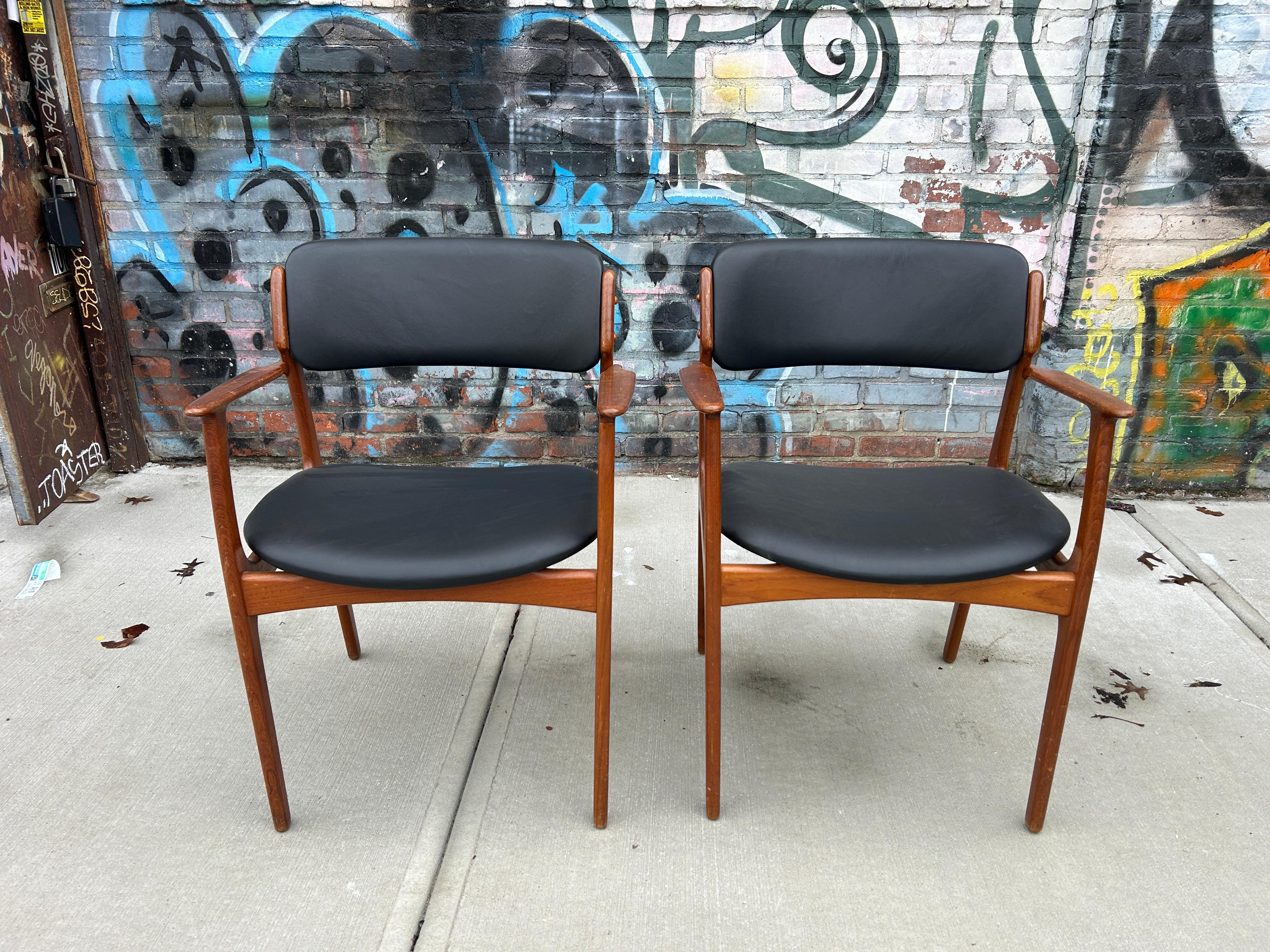 Pair of mid century danish modern Erik Buch Teak model 49 dining arm chairs. Beautiful black leather upholstery. Sold as a pair (2) chairs. Made in Denmark. Located in Brooklyn NYC.

Dimensions: H 32