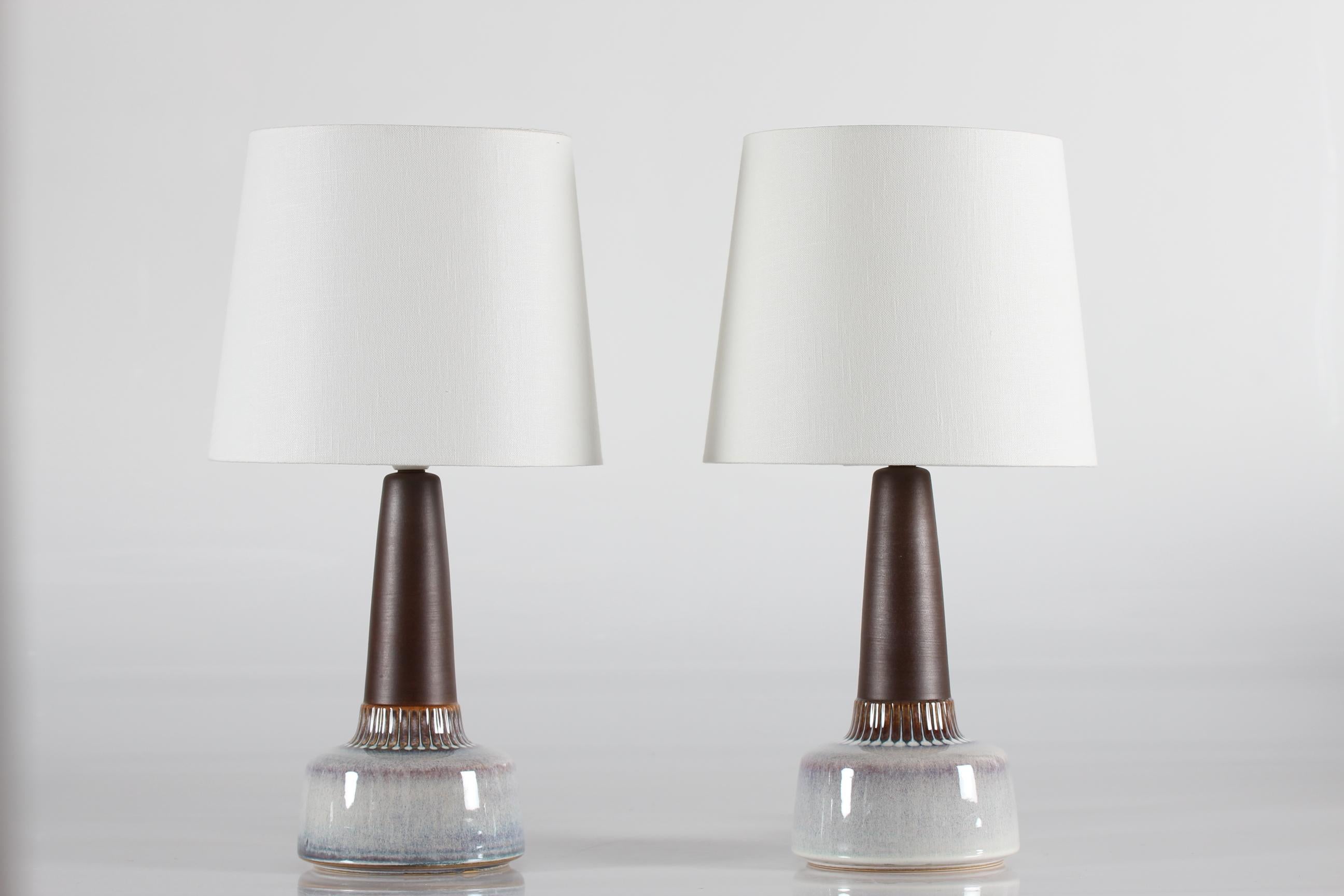 Pair of mid-century Danish table lamps by Danish ceramist Einar Johansen for Søholm. Made circa 1960's.

The lamp base has a matte brown neck contrasted by a shiny glaze in mother-of-pearl colors and circular dots around the lower part.

The
