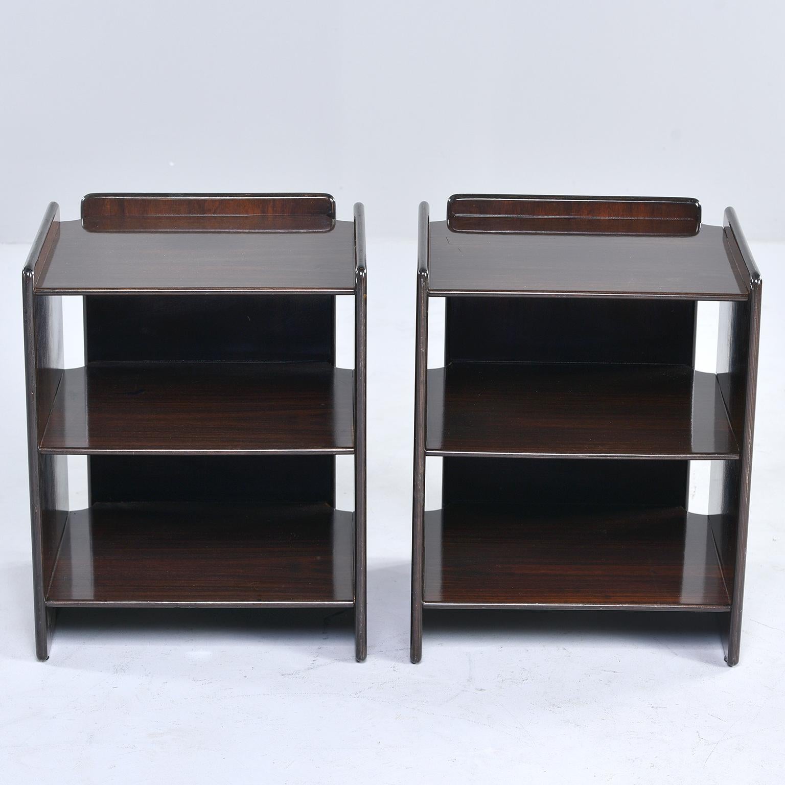 Pair of open shelf style side tables in dark walnut. Modified cubist style with open space between side and back panels. Unknown maker. Found in Italy. Sold and priced as a pair.