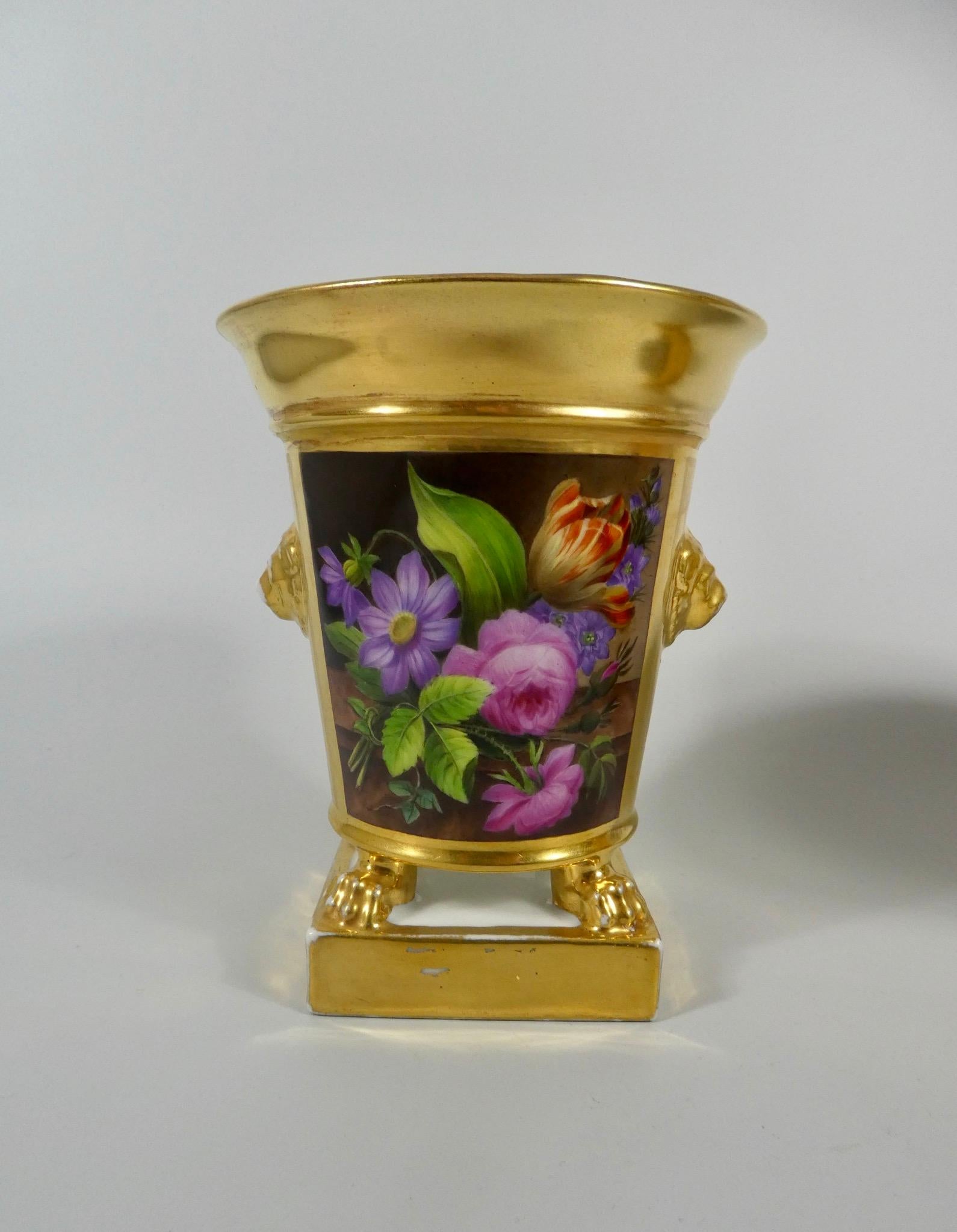 Pair of Darte Freres of Paris, porcelain pot pourri and covers, circa 1820. Both pot pourri having panels, exuberantly painted with vases of flowers, set upon marble plinths. All upon a gilt ground, tooled with further baskets of flowers, within