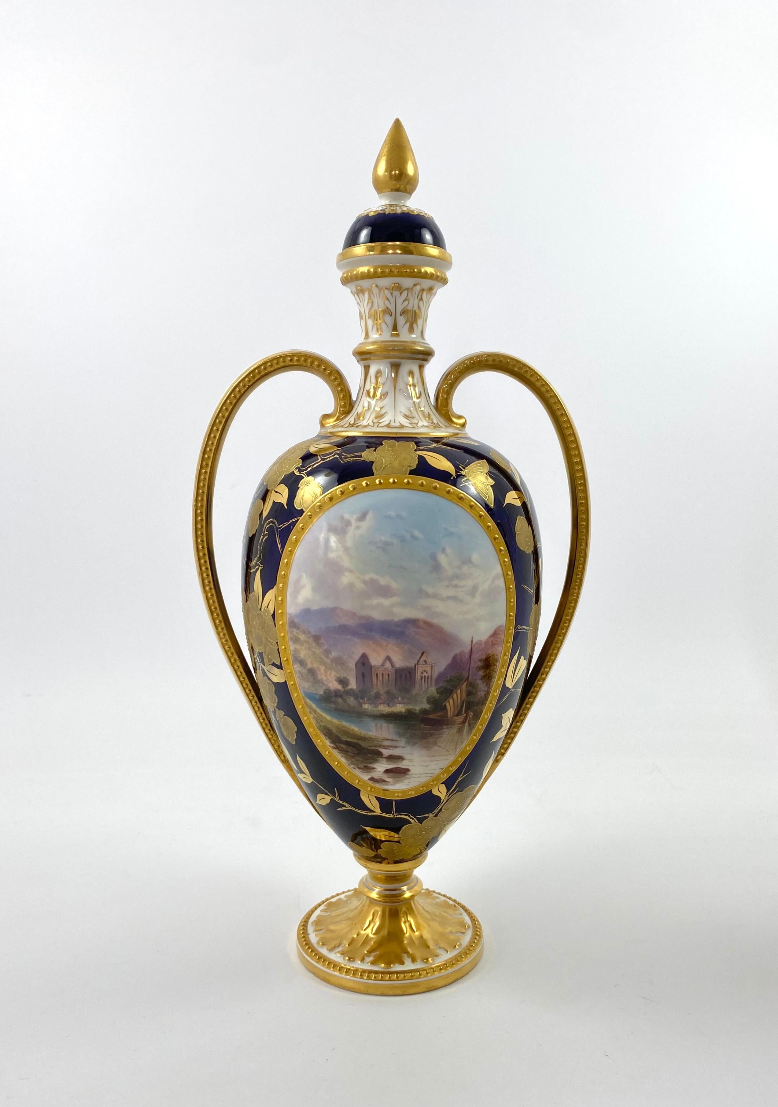 An exceptionally fine and rare pair of Davenport porcelain vases and covers, c. 1875. The Sevres style decorated vases, painted with large oval beaded gilt panels, containing scenes of a ruined monastery, and a ruined castle, in English rural