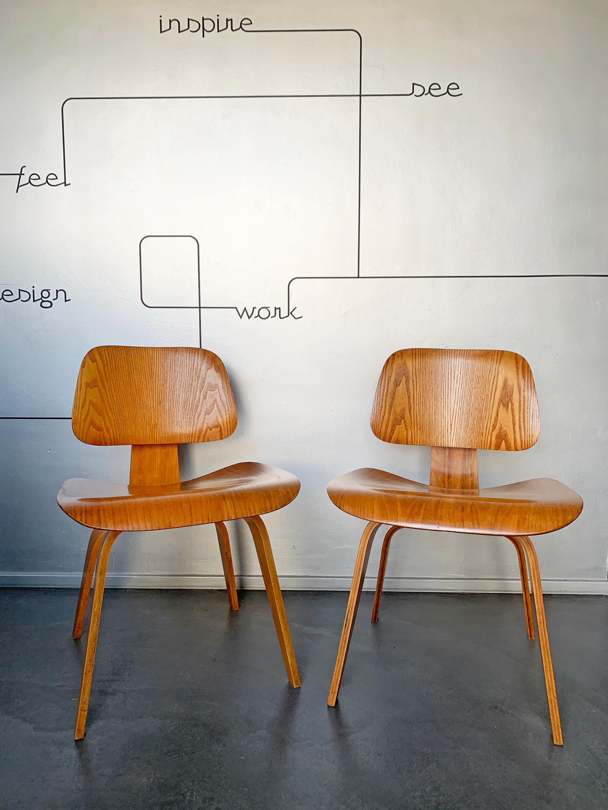 The DCW (Dining Chair Wood) chair has been created by Charles and Ray Eames around 1945.

These are first generation chairs produced by Evans Products Company and distributed by Herman Miller between 1946 and 1950. 
Both retain their original