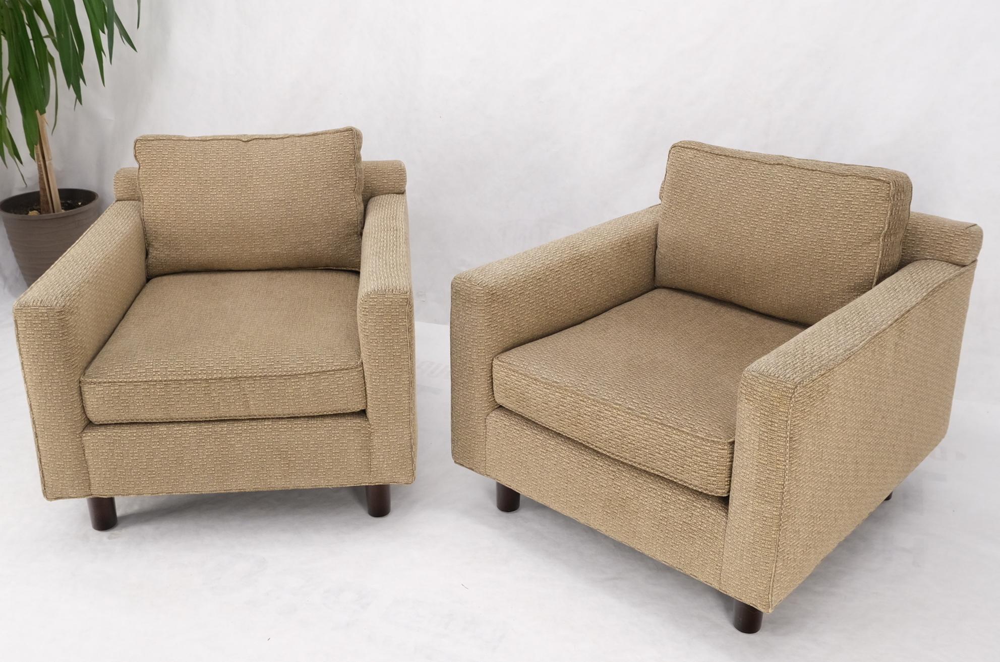 Pair of deep oatmeal fabric upholstery contemporary lounge chair on dowel legs.