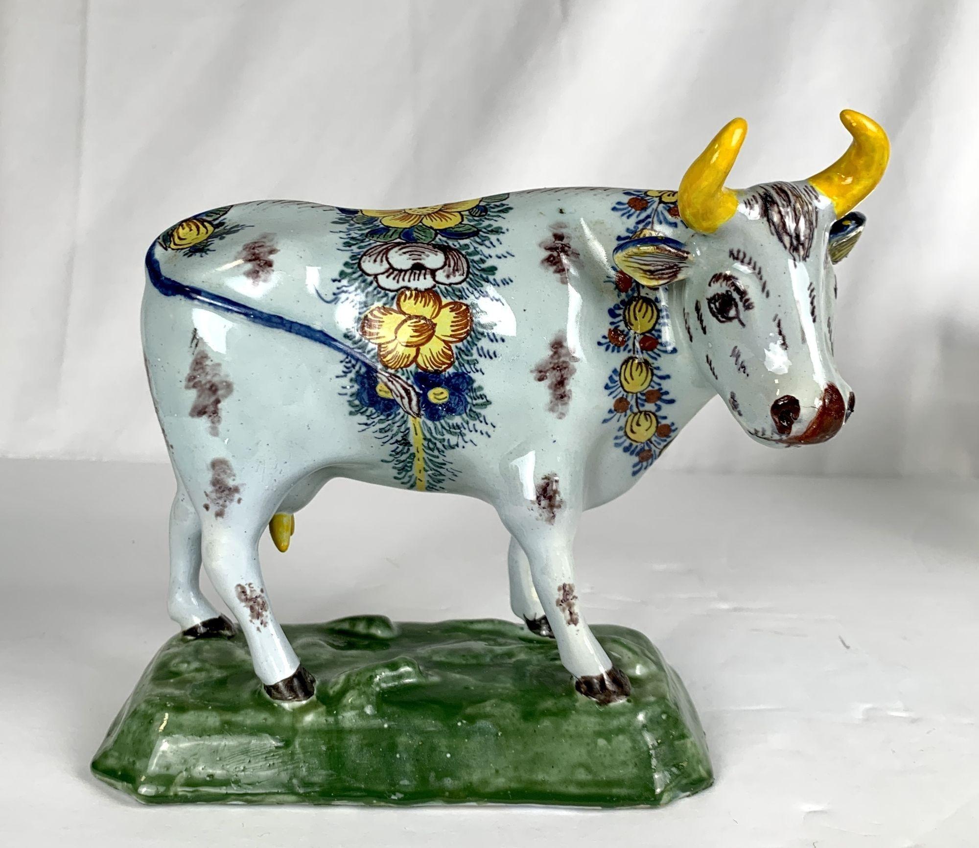 This beautiful pair of cows was made around 1785 in the city of Delft. 
Since the late seventeenth century, Dutch Delft cows have adorned mantelpieces, furniture, and window sills.
They were always produced in pairs, with their heads turned