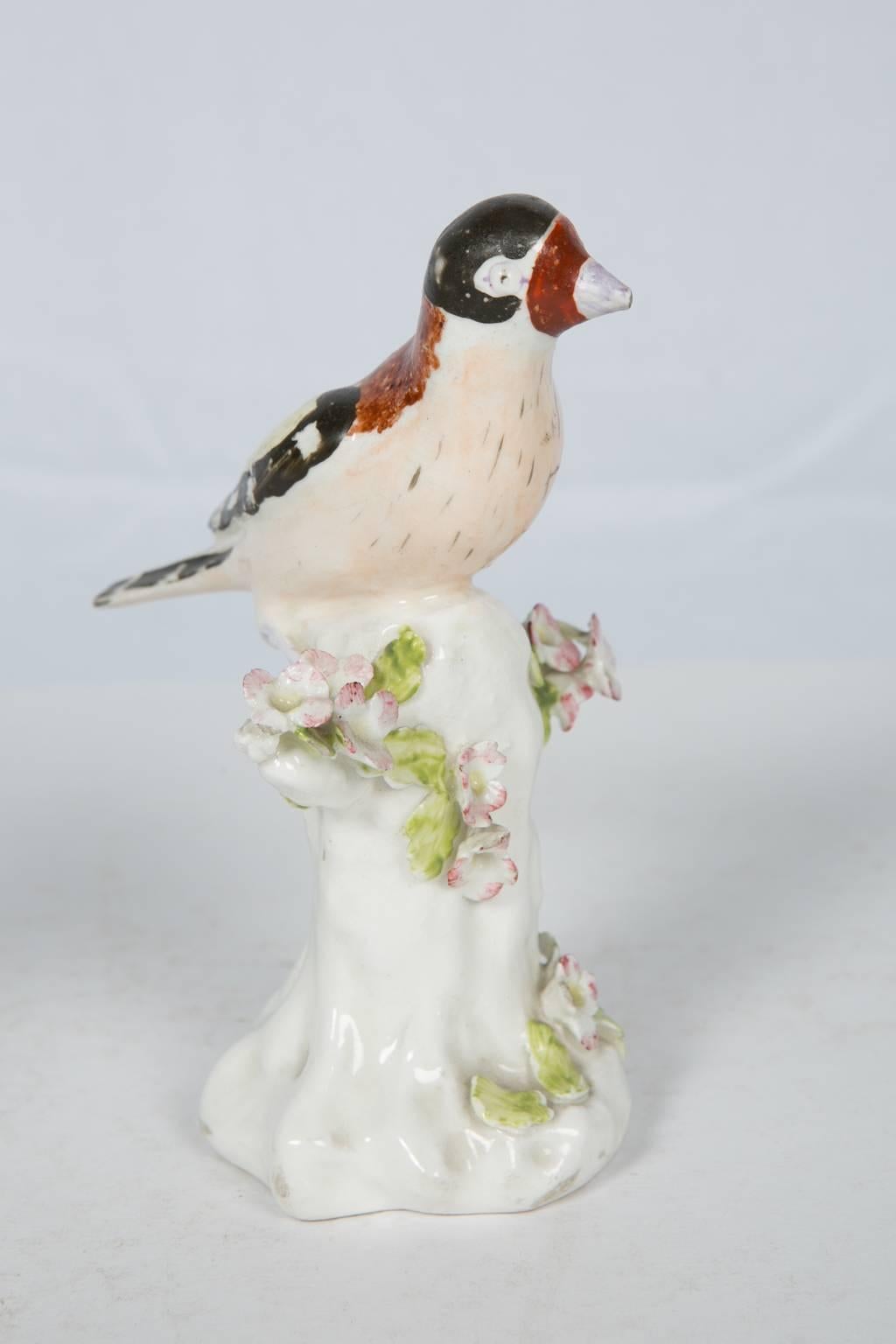 A pair of late 18th century Derby porcelain life-size figures of goldfinches. The goldfinch is an exquisite little bird with a beautiful high-pitched song. Each bird is shown perched on a tree stump which is lightly decorated with leaves and flower