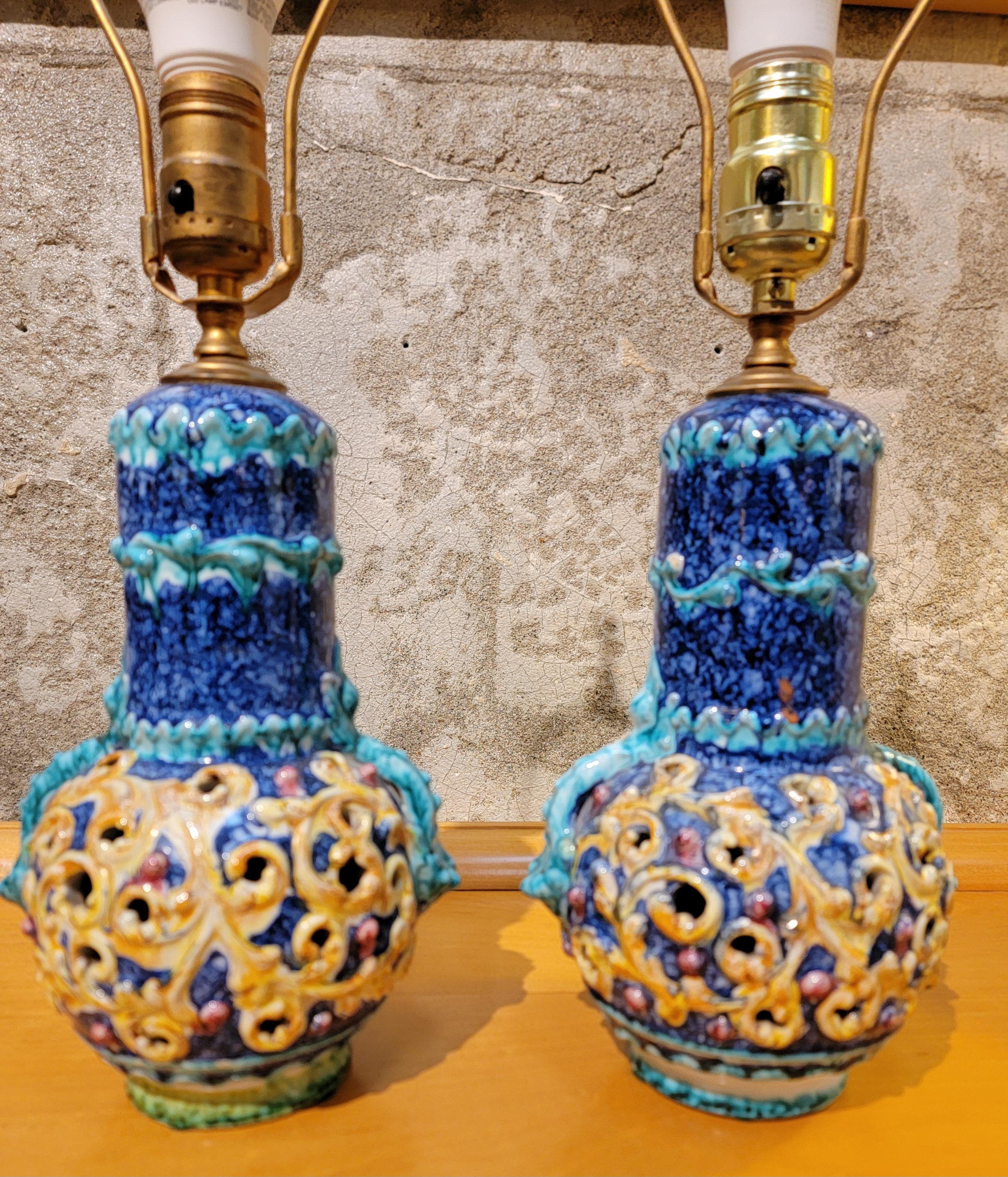 A small pair of ceramic lamps that appear to be Italian Capodimonte in origin. Cobalt blue and mustard yellow glaze colors. Lamp shades included. 

21.75 inches high.
10 inch diameter.

Ceramic base 6 inch diameter.
Shades 10 inch high, 10 inch