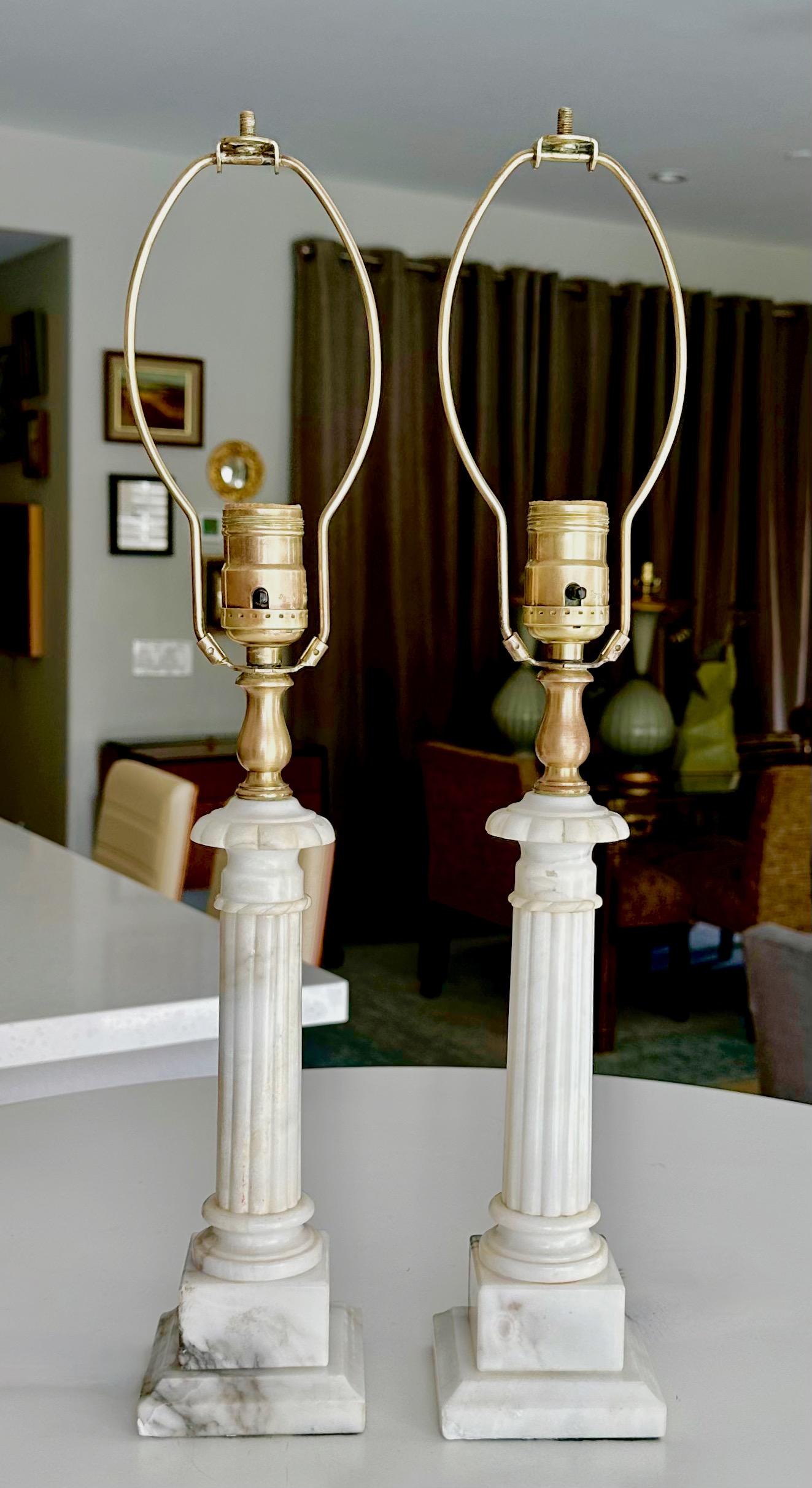 Pair of smaller scale Italian hand carved neoclassical style column form alabaster table lamps. Height to top of alabaster socket is 15