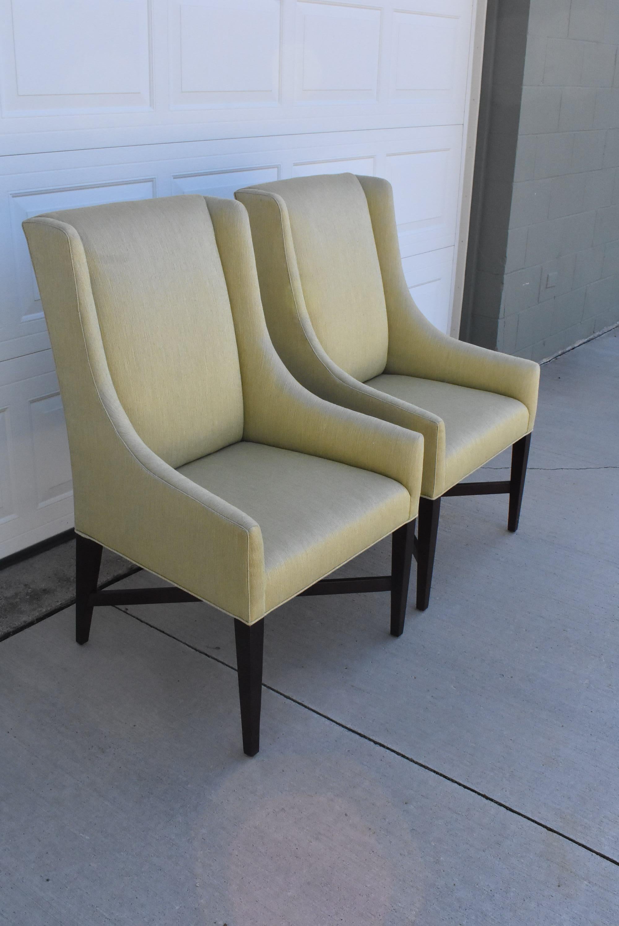 Pair of captain dining side chairs by Swaim. Straited light lemon lime upholstery. Espresso finished tapered legs and stretcher bars.