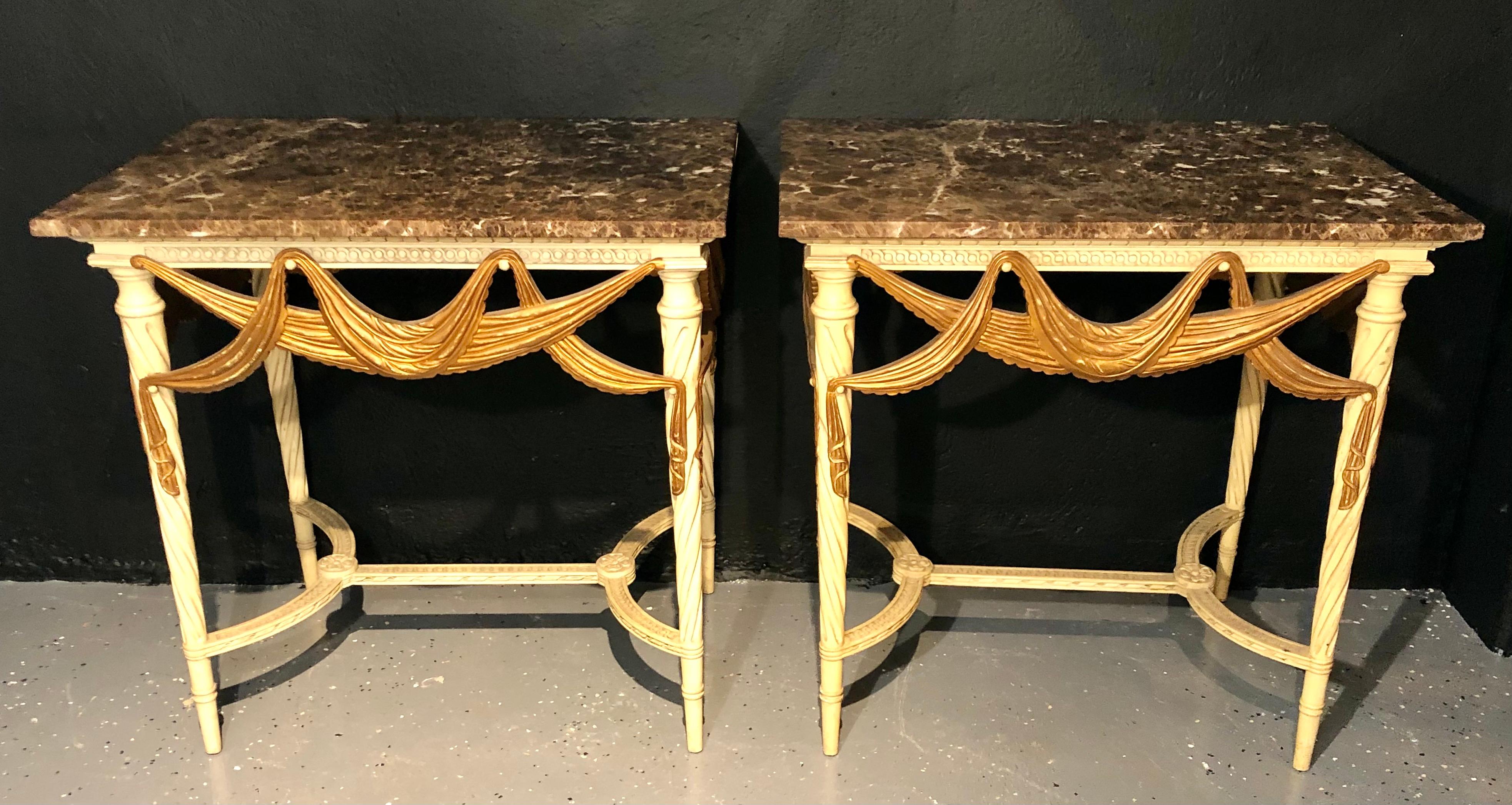 Pair of Dorothy Draper console, sofa or end tables. Each of these fabulous Hollywood Regency Tables are parcel-gilt and paint decorated with fine tassel and ribbon carvings on all sides. These quad decorated tables can sit up against a wall or