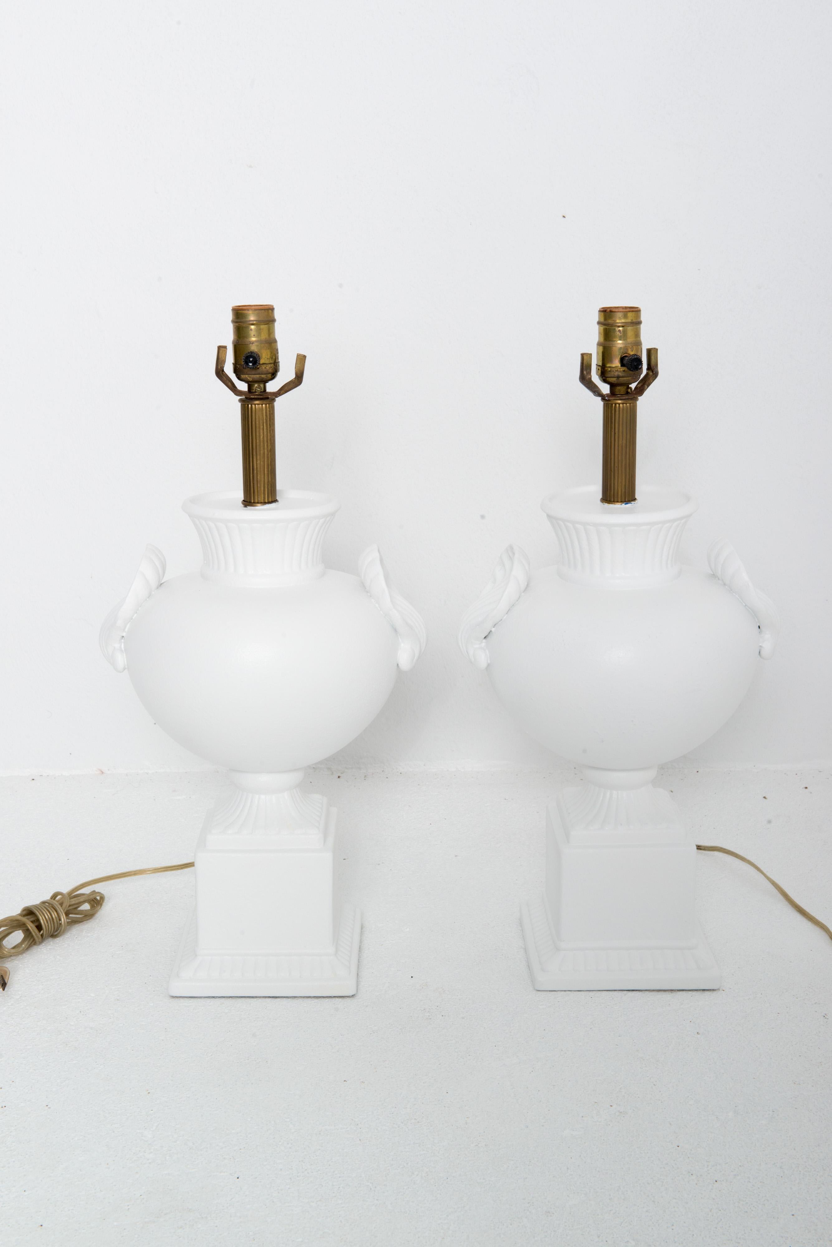 Pair of white painted plaster table lamps in the style of Dorothy Draper.  
Dramatically bulbous shape with large shell features on each lamp.
Harps and shades are not included. 