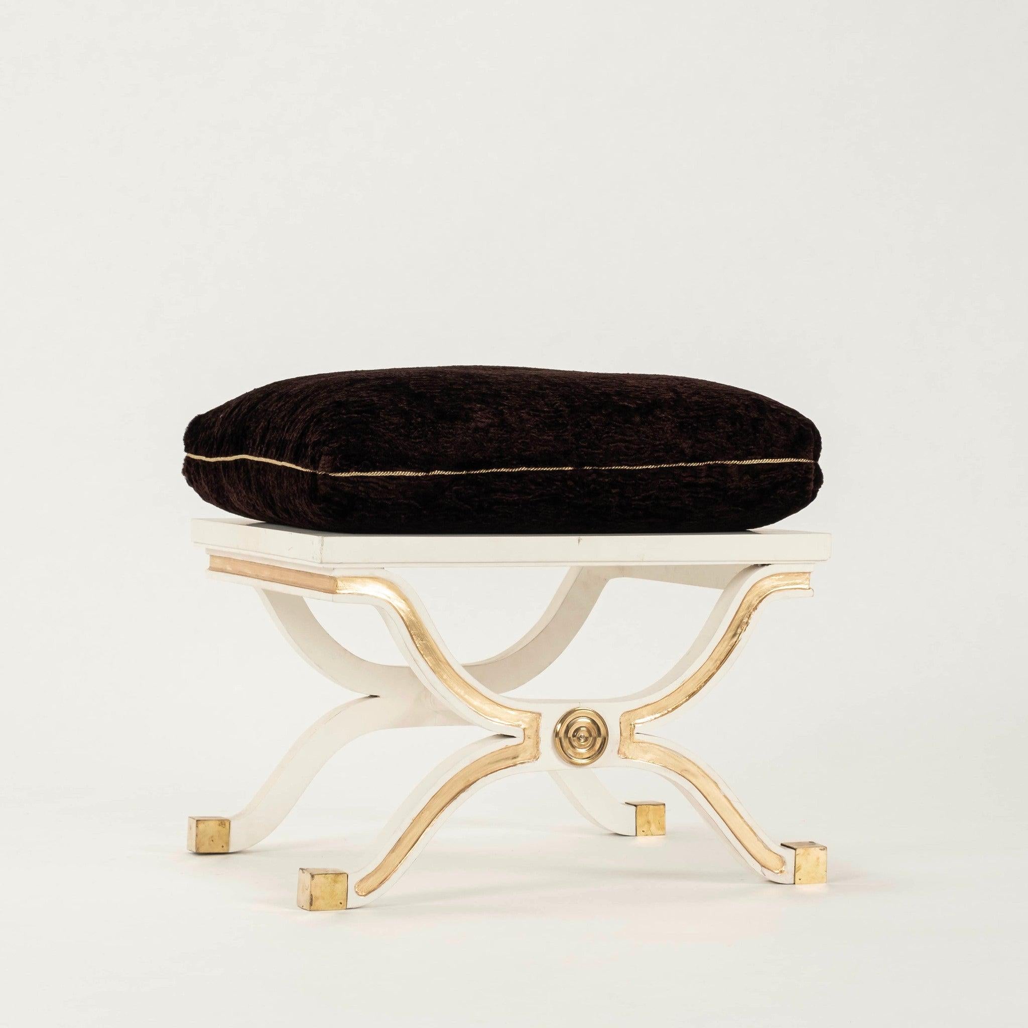 Pair of Mid-20th Century Dorothy Draper España curule benches for Heritage-Henredon featuring white painted wood frames with gold gilt detail and newly upholstered espresso Astrakhan silk mohair seat cushions.