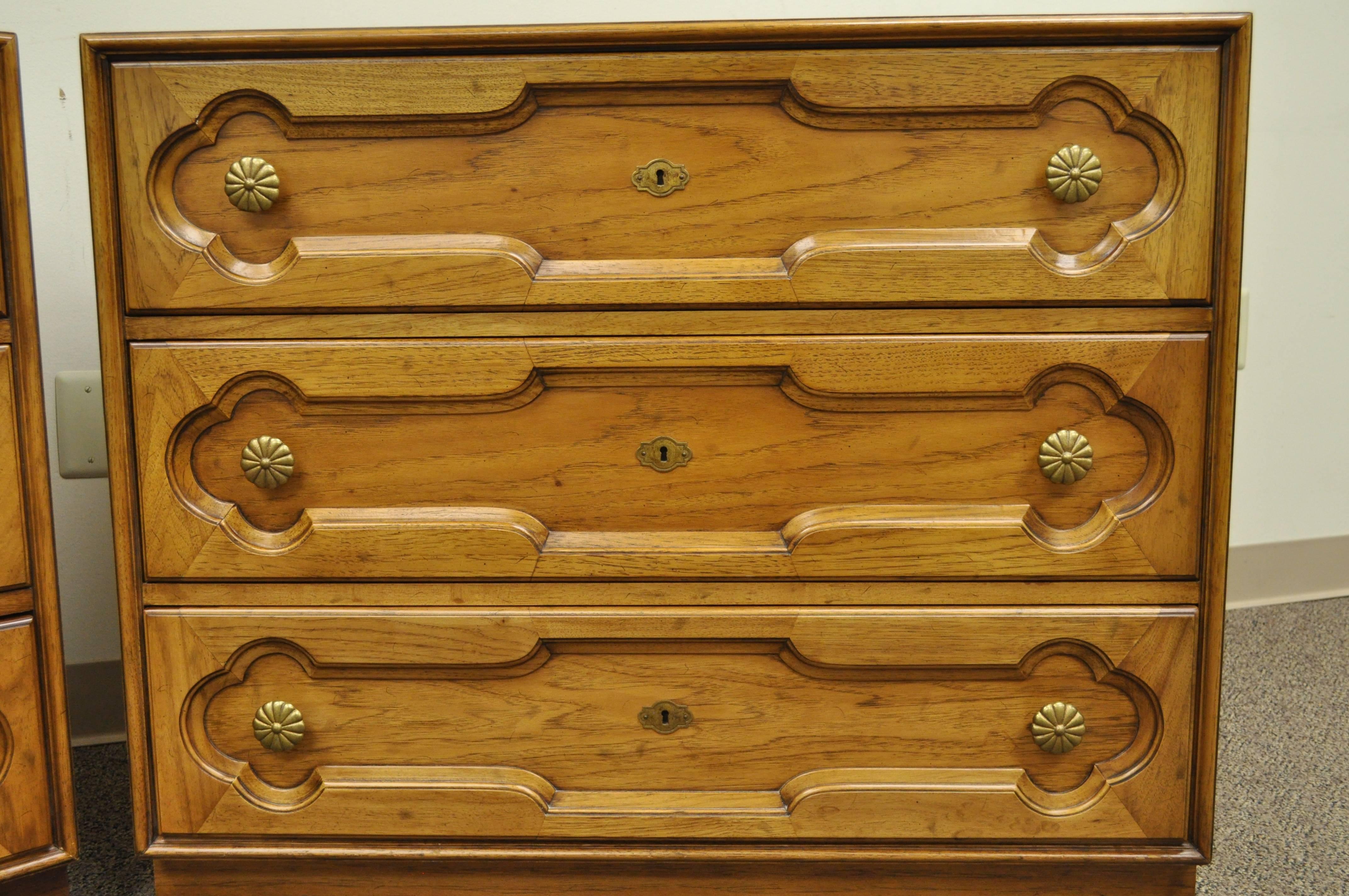 Quality pair of three-drawer commodes by Drexel Heritage. Item features solid brass hardware, three dovetail constructed drawers each, carved drawer fronts and clean lines. Style and quality is very similar to that of Dorothy Draper. Designer is