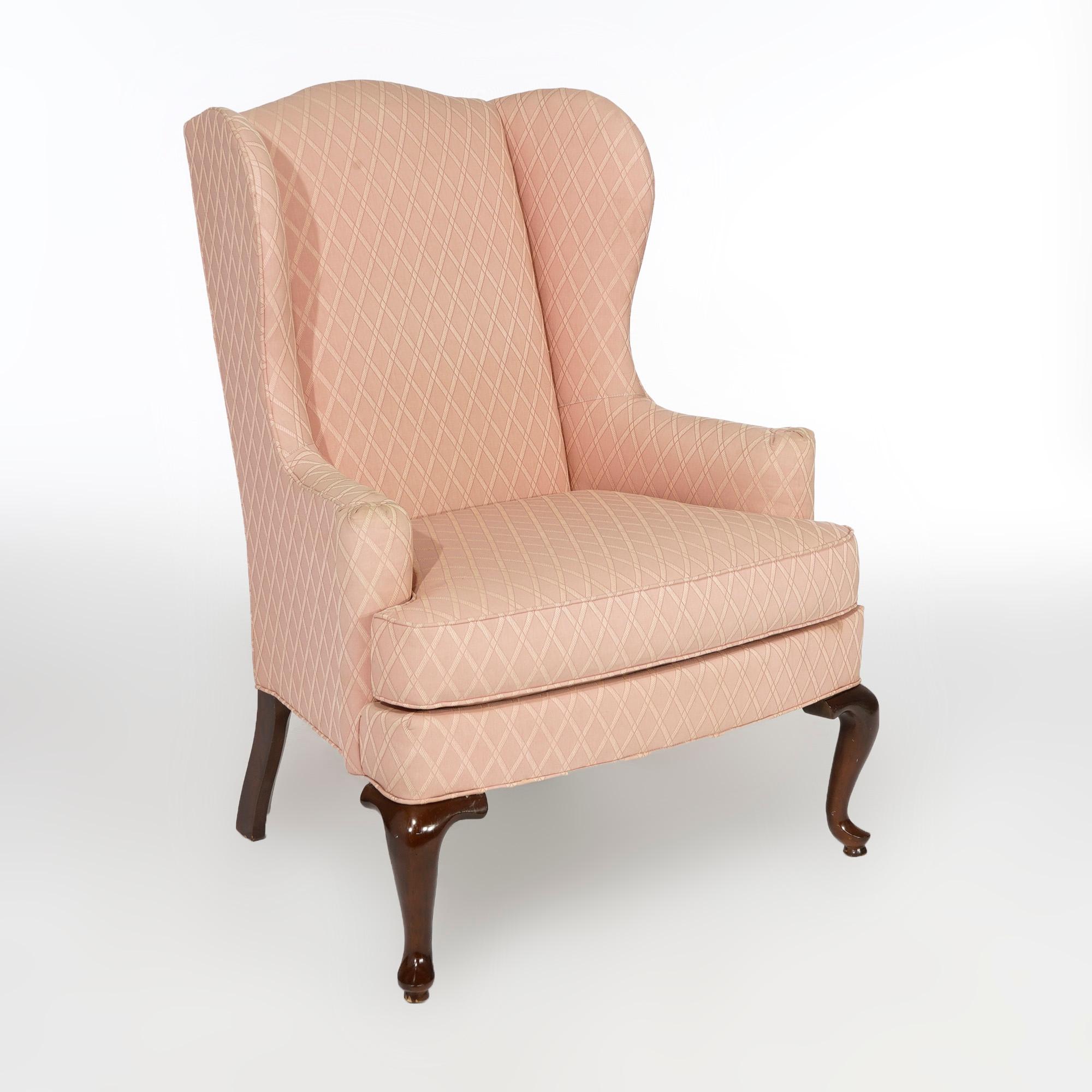 A pair of Queen Anne upholstered fireside chairs by Drexel offer wingback form with scroll arms and raised on cabriole legs terminating in pad feet, maker tag as photographed, 20th century

Measures- 42.5'' H x 32.5'' W x 29.5'' D

Catalogue