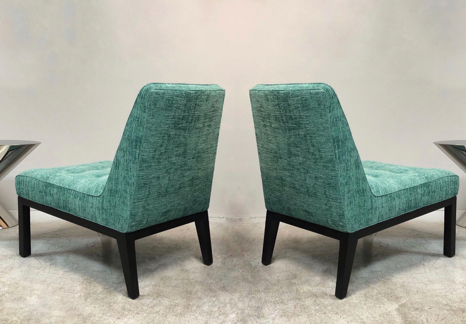 A pair of Dunbar lounger chairs by Edward Wormley. Dark walnut bases with turquoise upholstery.