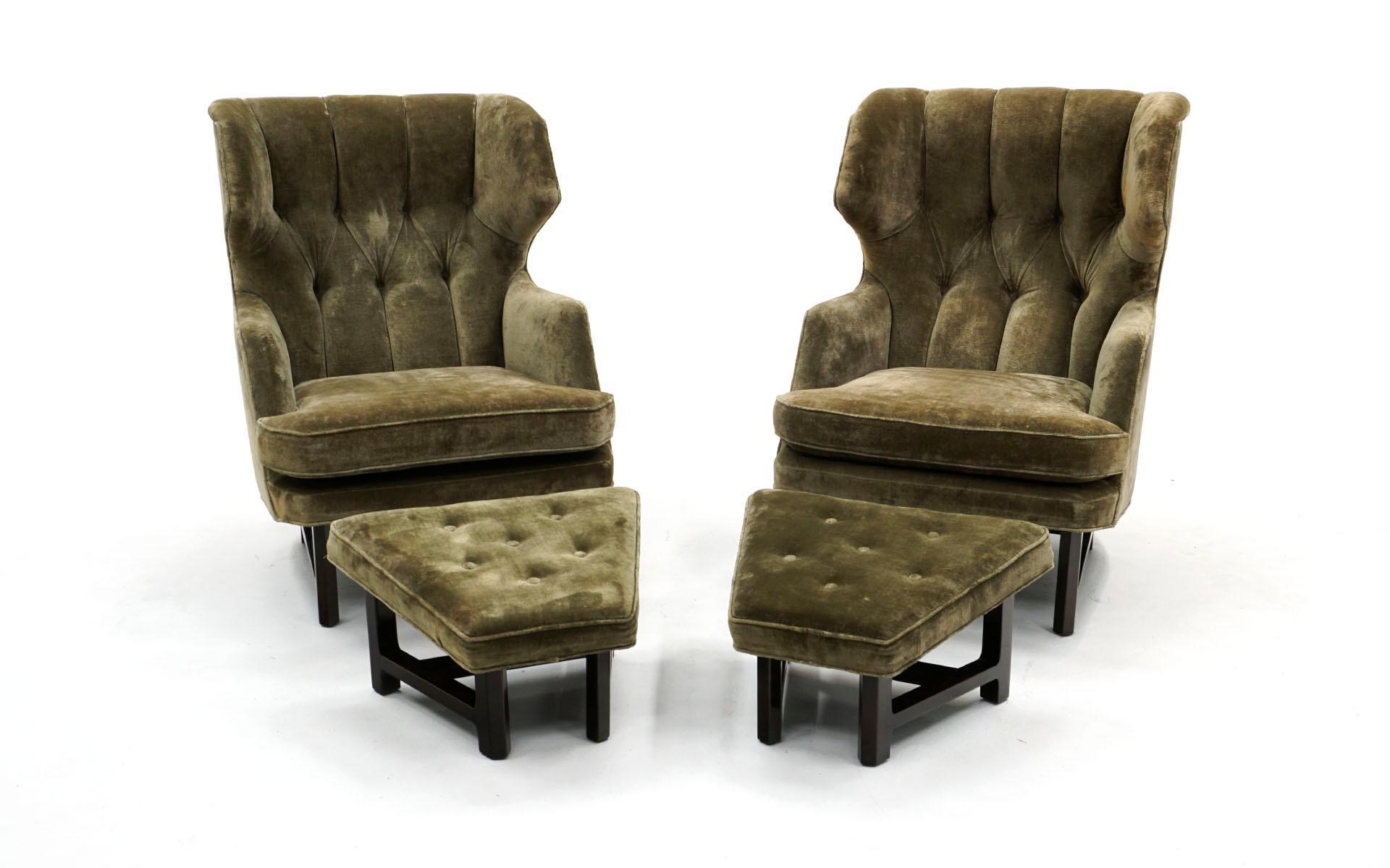 Original pair of tufted back wingback lounge chairs with ottomans designed by Edward Wormley for the Janus Collection produced by Dunbar Furniture Company, 1950's. Two chairs and two ottomans in the original glamorous deep green avocado velvet