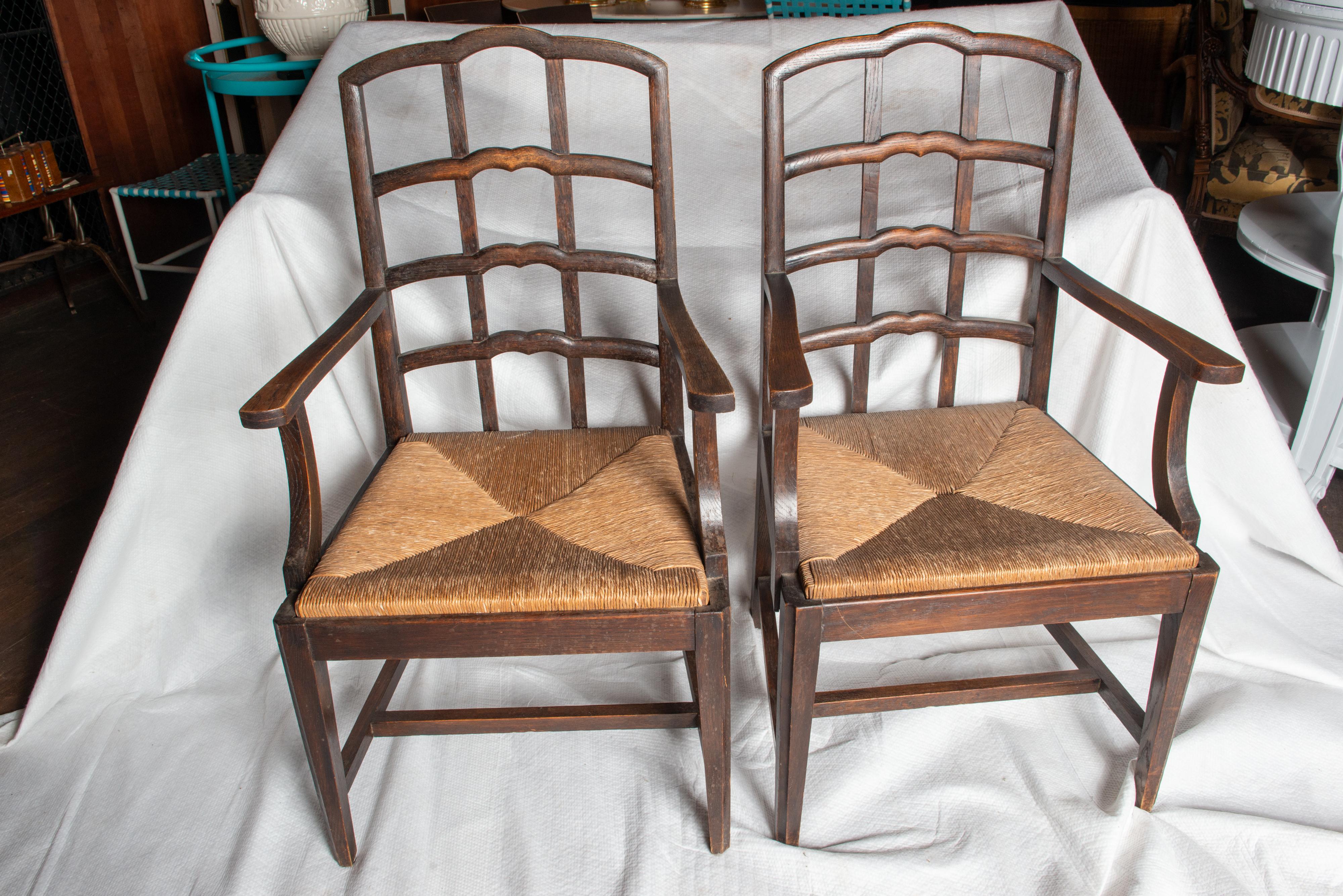 A sturdy pair of stylish early 20th century Dutch wood arm chairs with rush seats. Chairs have a very interesting and comfortable seat back design.
A versatile pair of chairs that would enhance any style interior.
