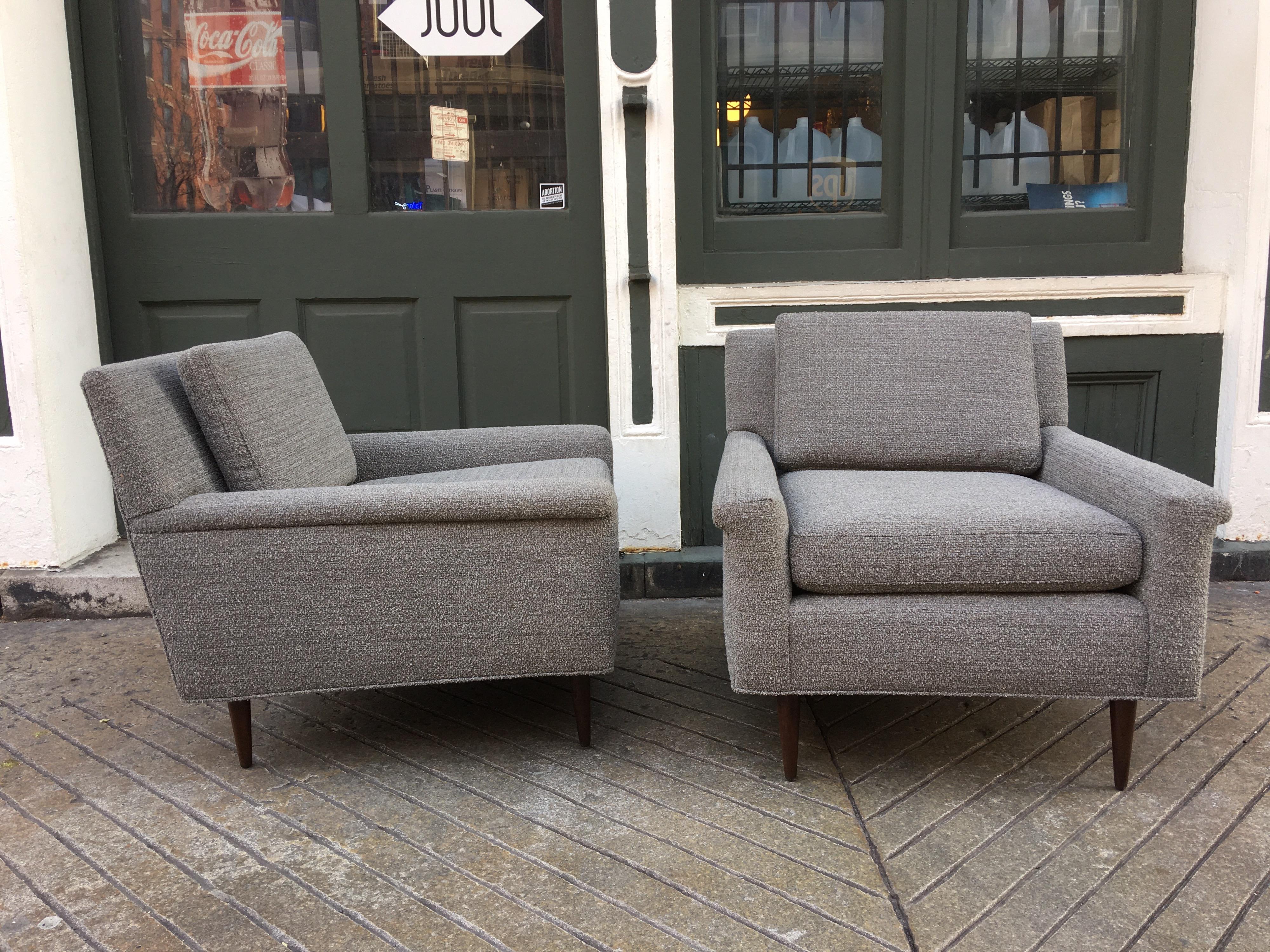 Pair of DUX upholstered lounge chairs, newly upholstered in a nubby gray and white fabric. Walnut legs sit slightly back from corners. Low profile perfect not to block the view!