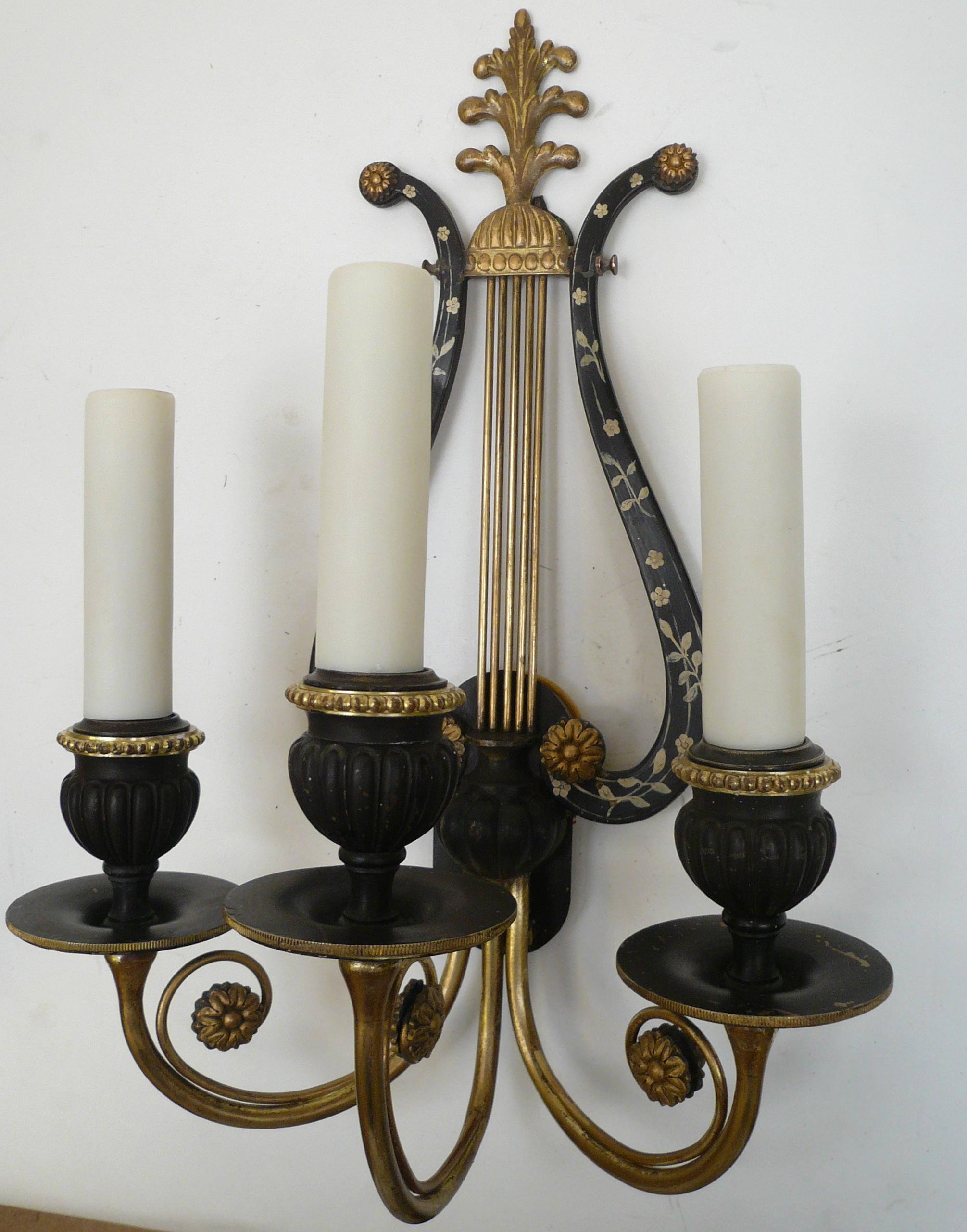 This quality pair of Caldwell bronze sconces feature hand painted floral motifs, and gilt rosettes.