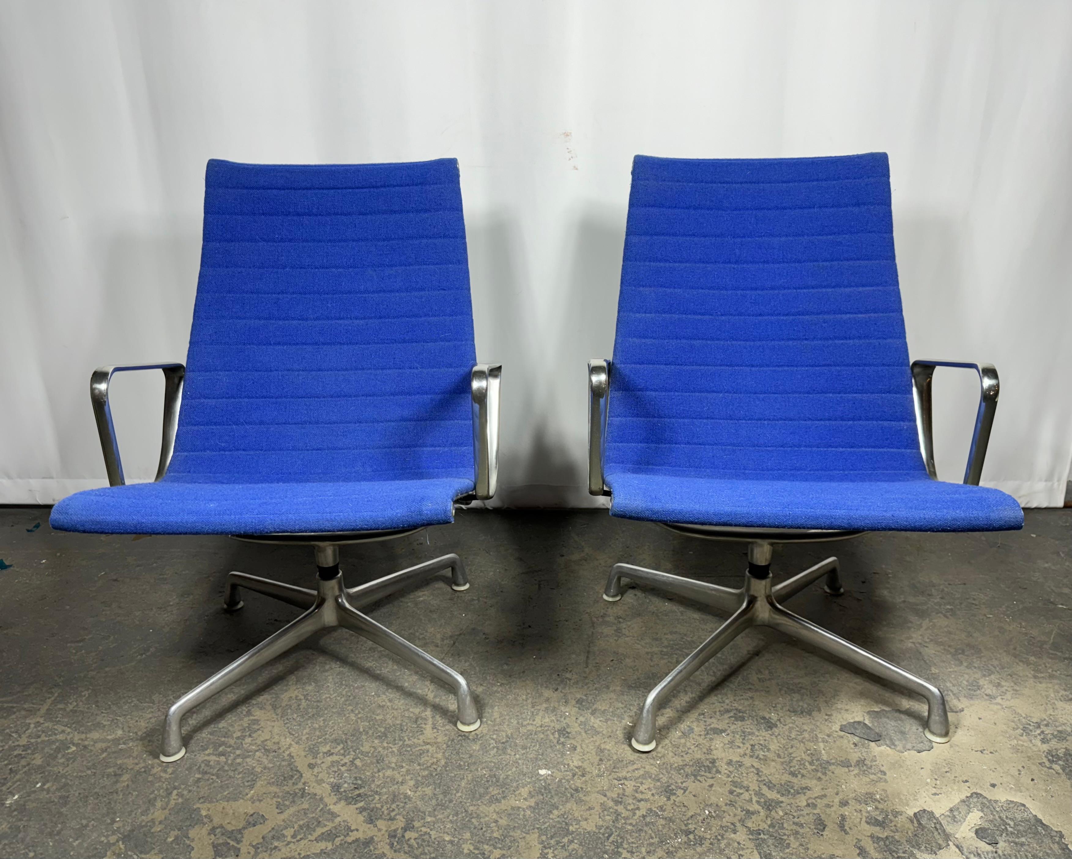 Stunning Pair Electric Blue  Eames lounge chairs from the 'Aluminium Group'.Collection. 

Designed by Charles and Ray Eames in 1958, The aluminium chair is one of the most outstanding furniture designs of the 20th century.

In great condition with
