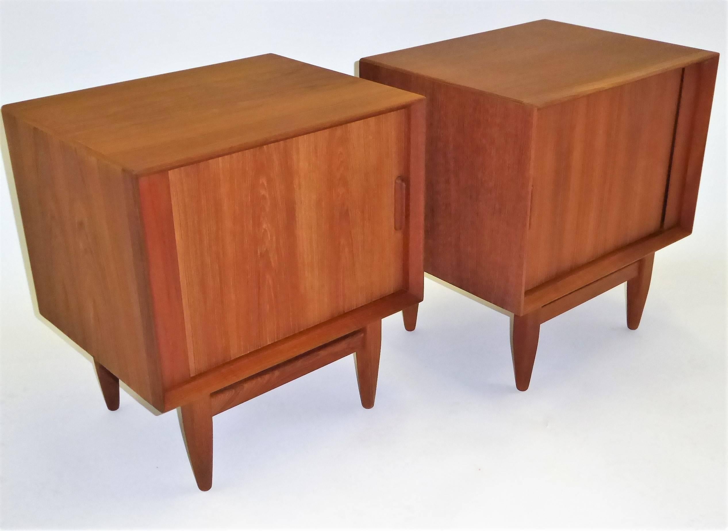 Beautiful pair of Danish nightstands in teak by Arne Wahl Iversen for Falster Møbelfabrik. Tambour doors open to reveal a shelf and drawer. These bedside tables are finished all around. In very good to excellent condition, they date back to the
