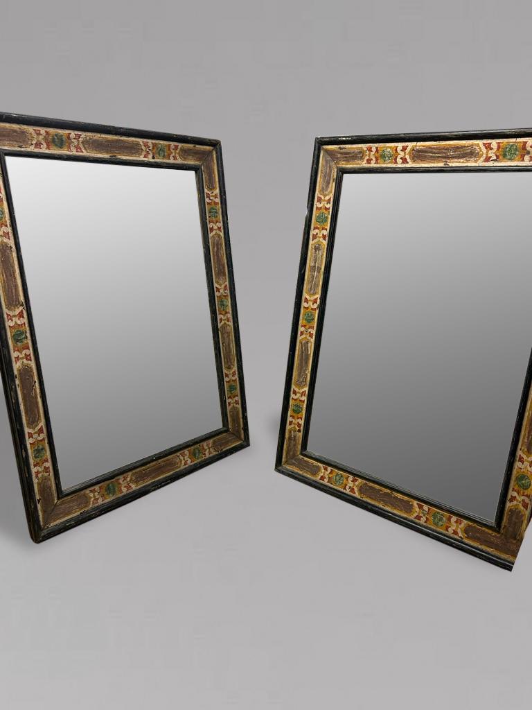 A pair of one of a kind antique Italian Empire Period (early 19th Century) carved wood Casetta frames. These are of a very high quality hand painted rectangular solid wood frames with aged modern mirror plates. A repeated pattern decorates these