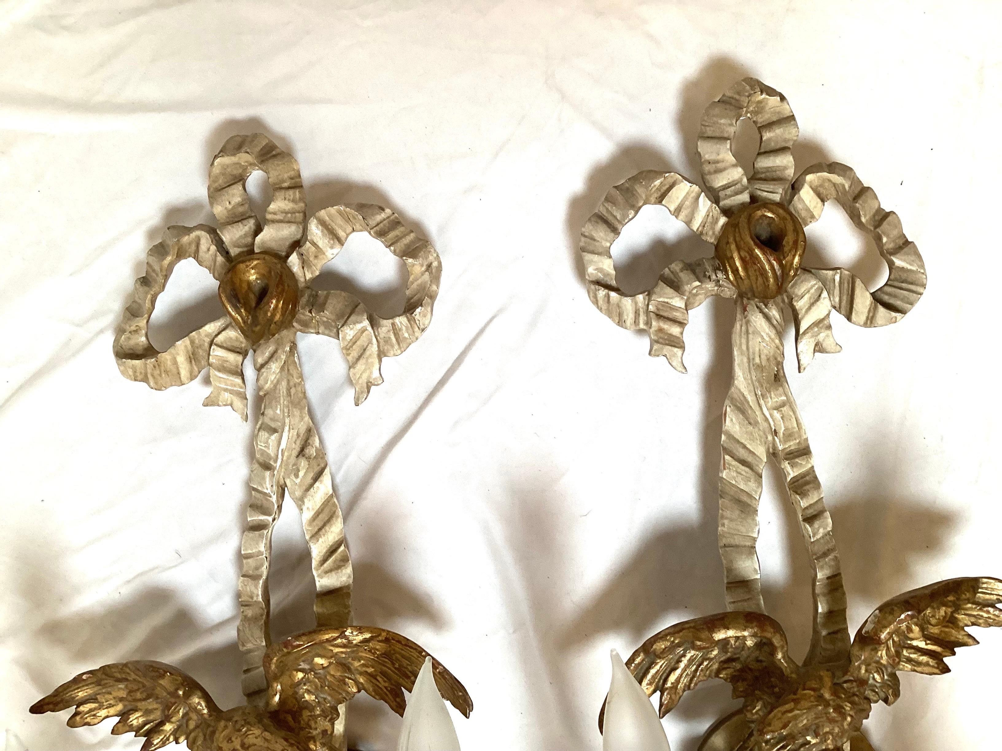 Pair of early 20th century hand carved eagle motif gilt wood wall sconces.
Nicely carved and made, will fit in with any traditional American decor.