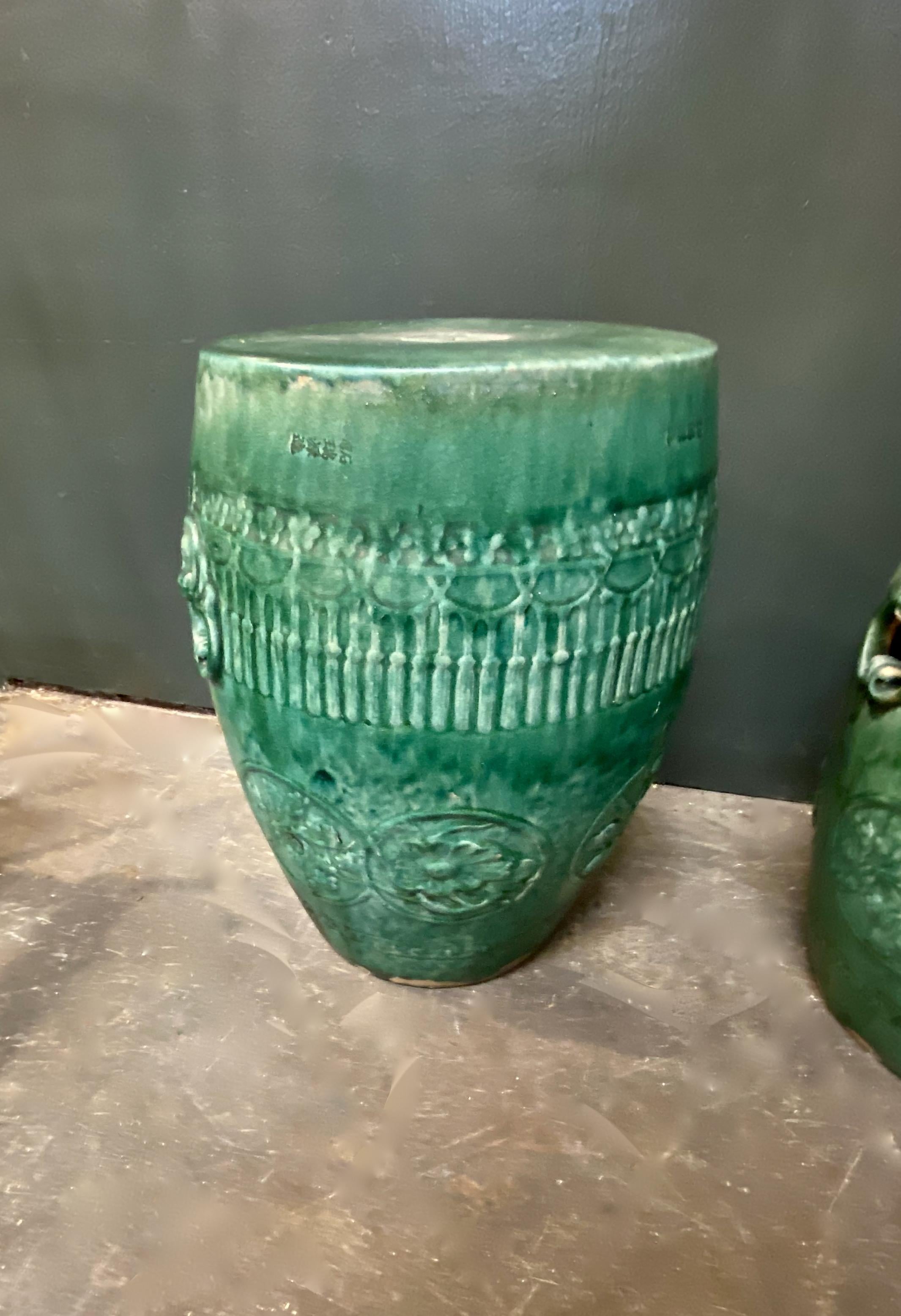 This is an outstanding pair of early to mid-20th century Chinese garden stools. The intense mottled green drip glaze of the stools combined with the perfect level of natural patina would make these stools the focal point of any room from mid-century