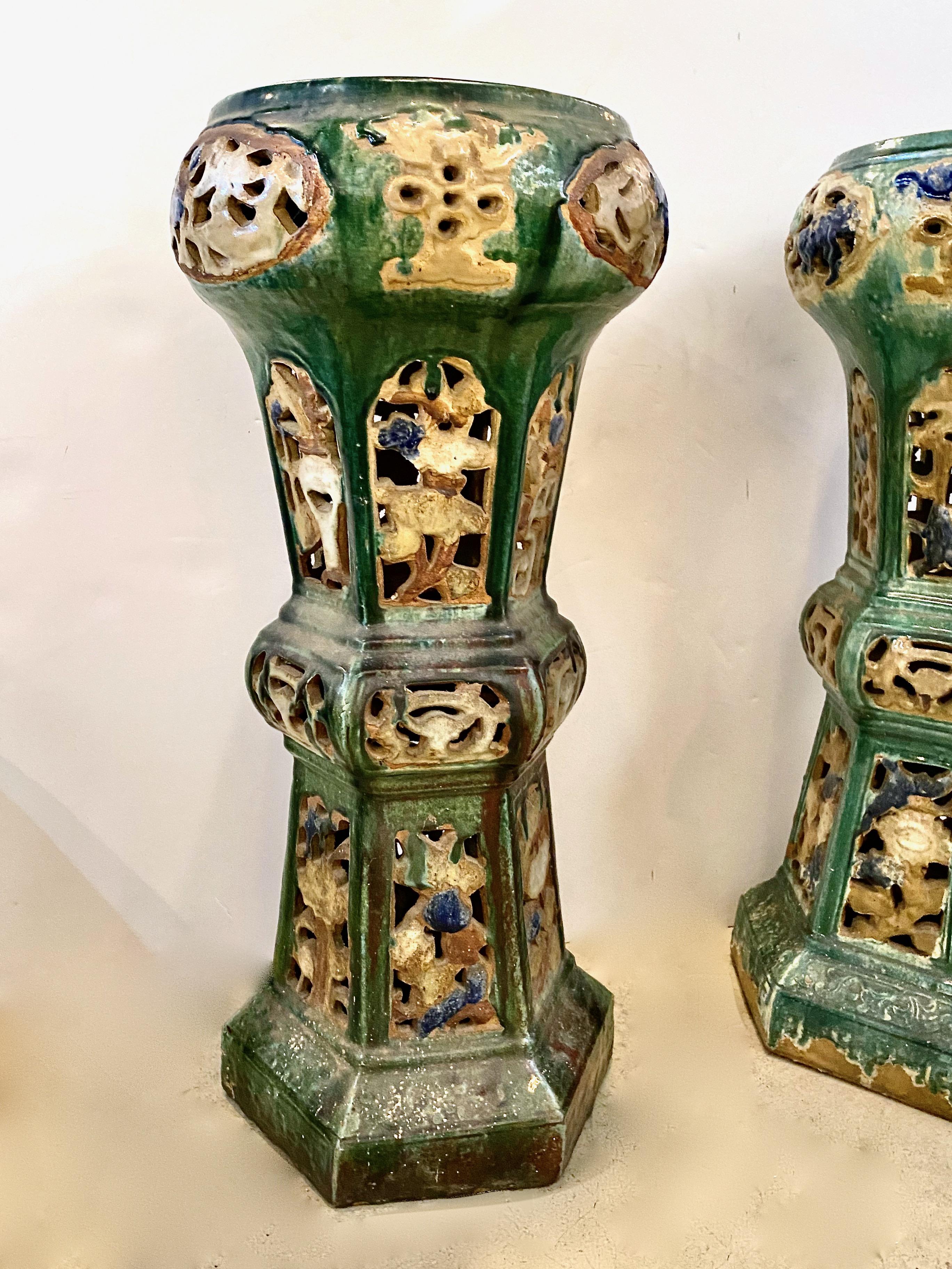 This is an outstanding near pair of Chinese Sancai terra cotta pedestals or stands. This pair dates to the early 20th c. and has acquired a rich natural patina. The green Sancai glaze highlighted by ivory and deep blue makes these pedestals great