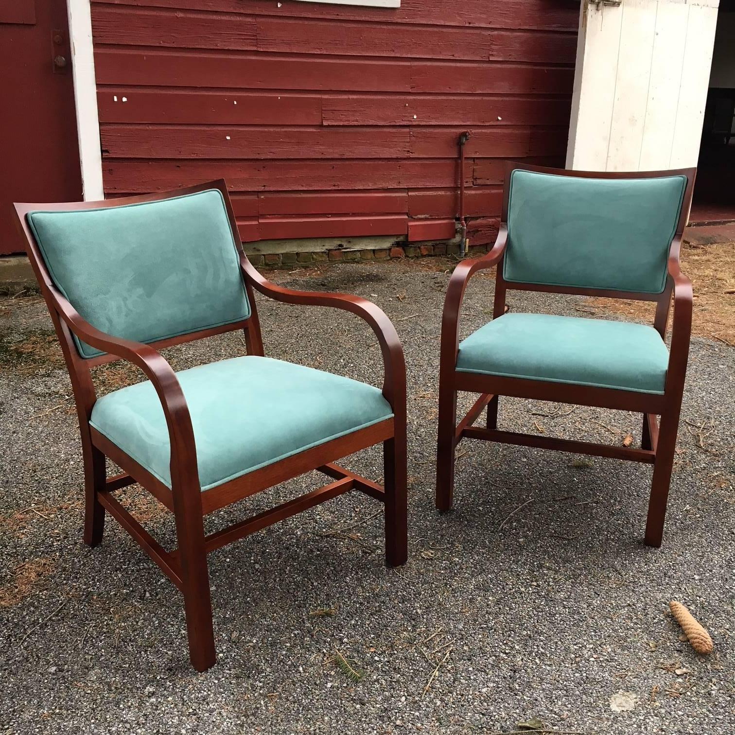 Fabulous pair of early 20th century Danish modern occasional chairs in the manner of Frits Henningsen. Ca. 1940.  

Wonderful sexy iconic swing to the arms and stunning unusual curved back, with high quality tight grain mahogany offset by Holly Hunt
