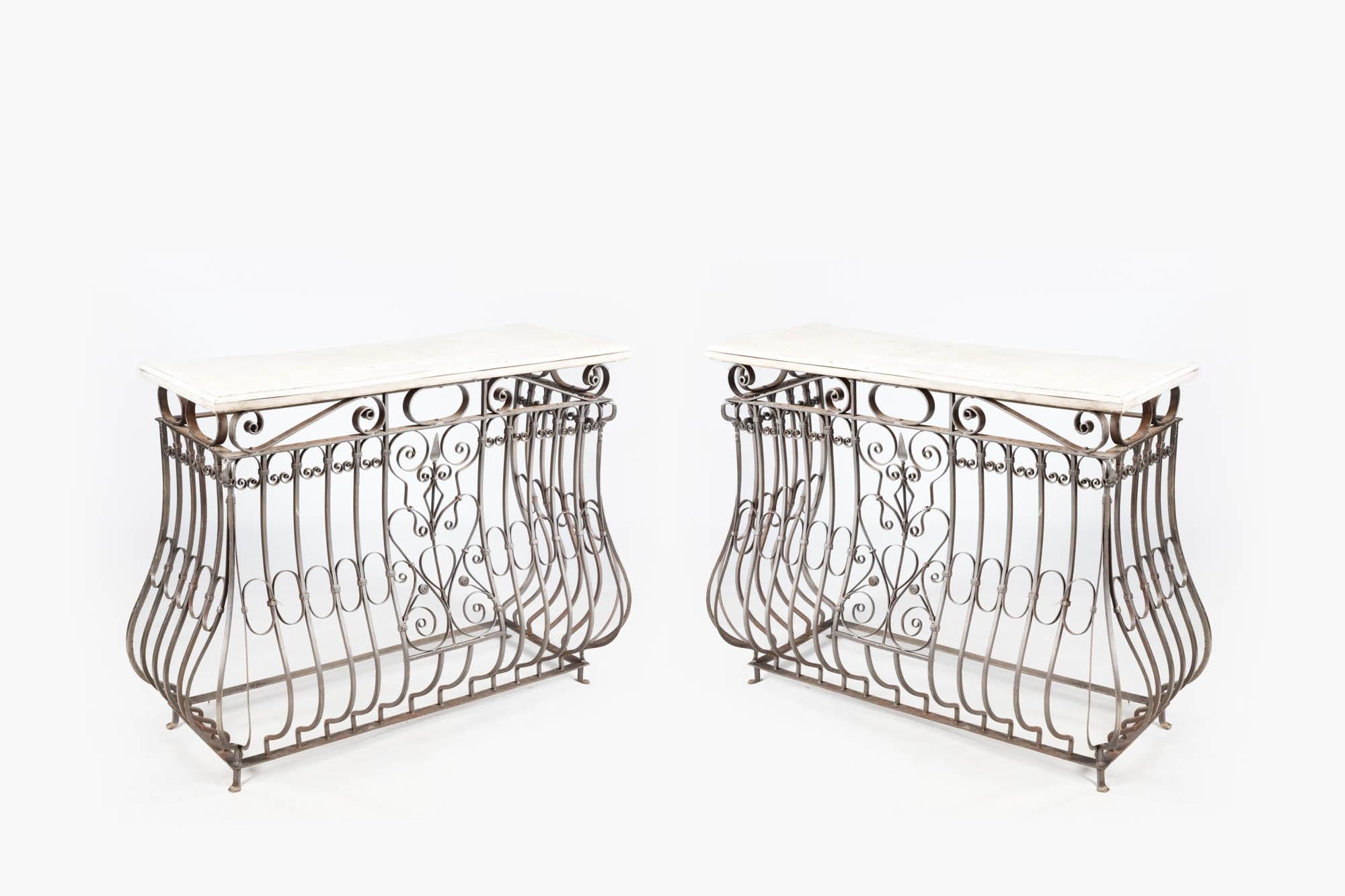 Pair early 20th Century decorative wrought iron balconies with ornamental scrolling. The pair have been re-styled to work as console tables complete with simple rectangular wooden tops.