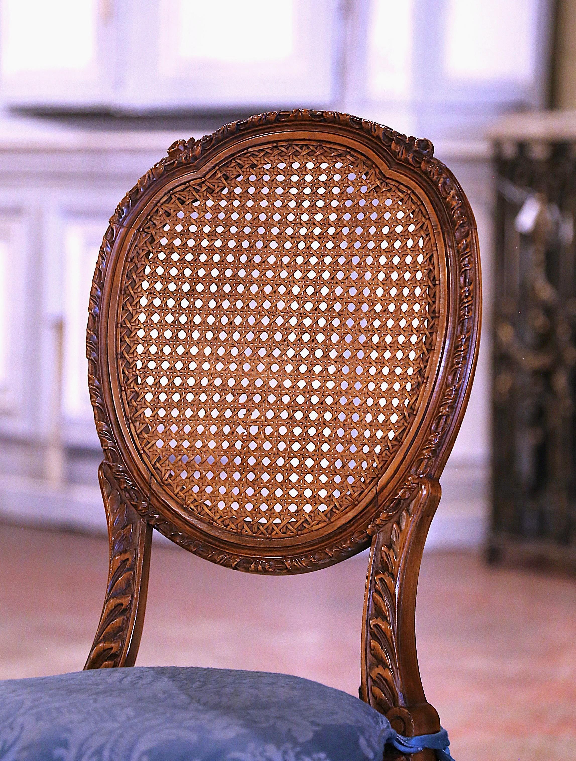 Hand-Carved Pair Early 20th Century French Louis XVI Carved Walnut and Cane Vanity Chairs For Sale